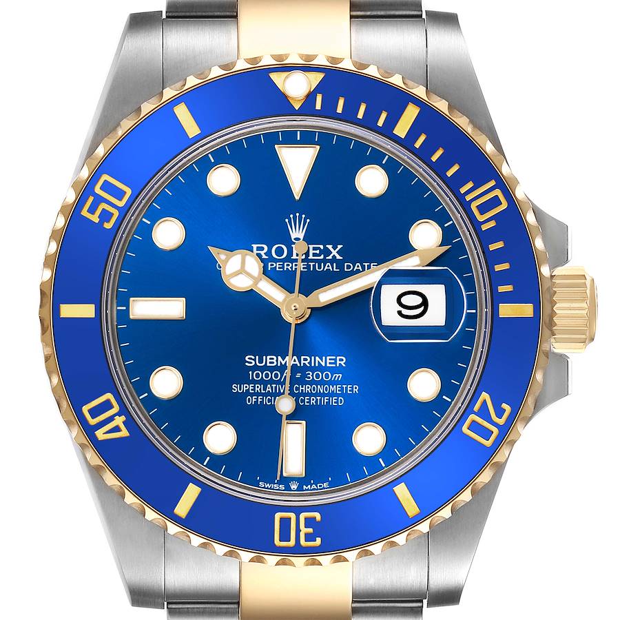 The Rolex Submariner watch is shown from a front angle, highlighting its blue dial, gold bezel, and date feature.