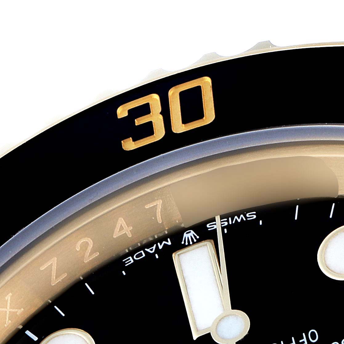 This image shows a close-up of the bezel and dial of a Rolex Submariner 126618 Men's Yellow Gold Black Dial 126618 Men's Yellow Gold Black Dial watch, focusing on the "30" marker and partial minute hand.