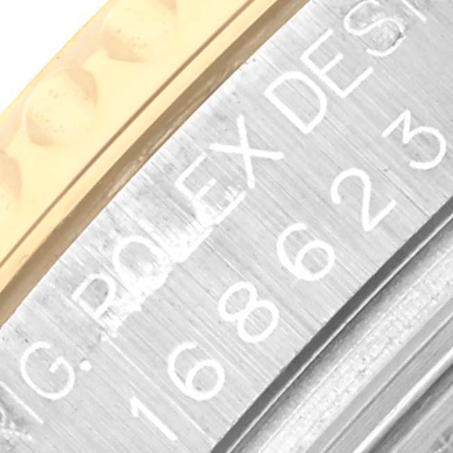 The close-up image shows the engraved side of a Rolex Yacht-Master 168623 Men
s Steel and Gold (two tone) White Dial 168623 Men
s Steel and Gold (two tone) White Dial, highlighting the model number and part of the bezel.