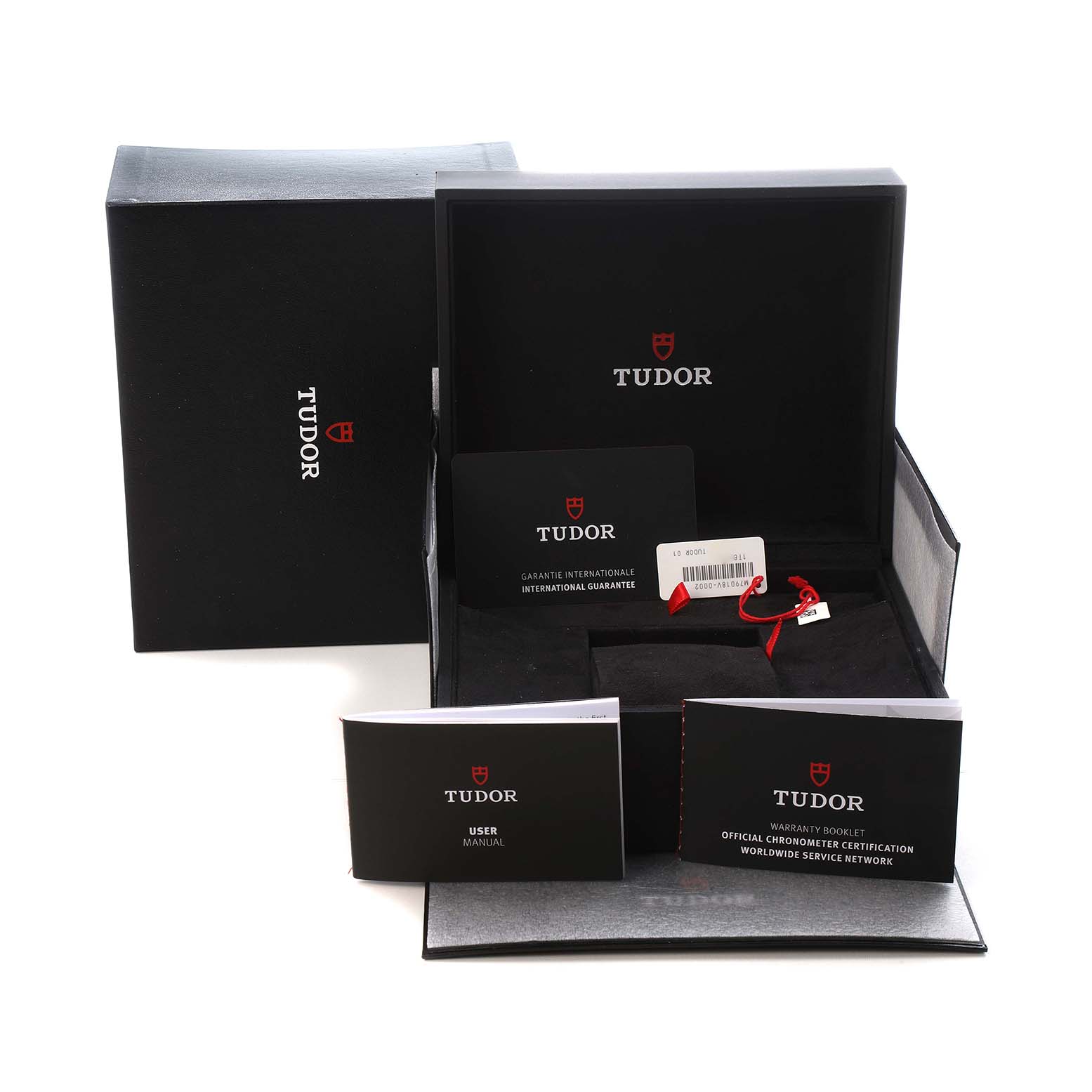 The Tudor Heritage Black Bay M79018V-0001 Men's Yellow Gold Green Dial packaging is shown, featuring the box, user manual, warranty booklet, and a tag.