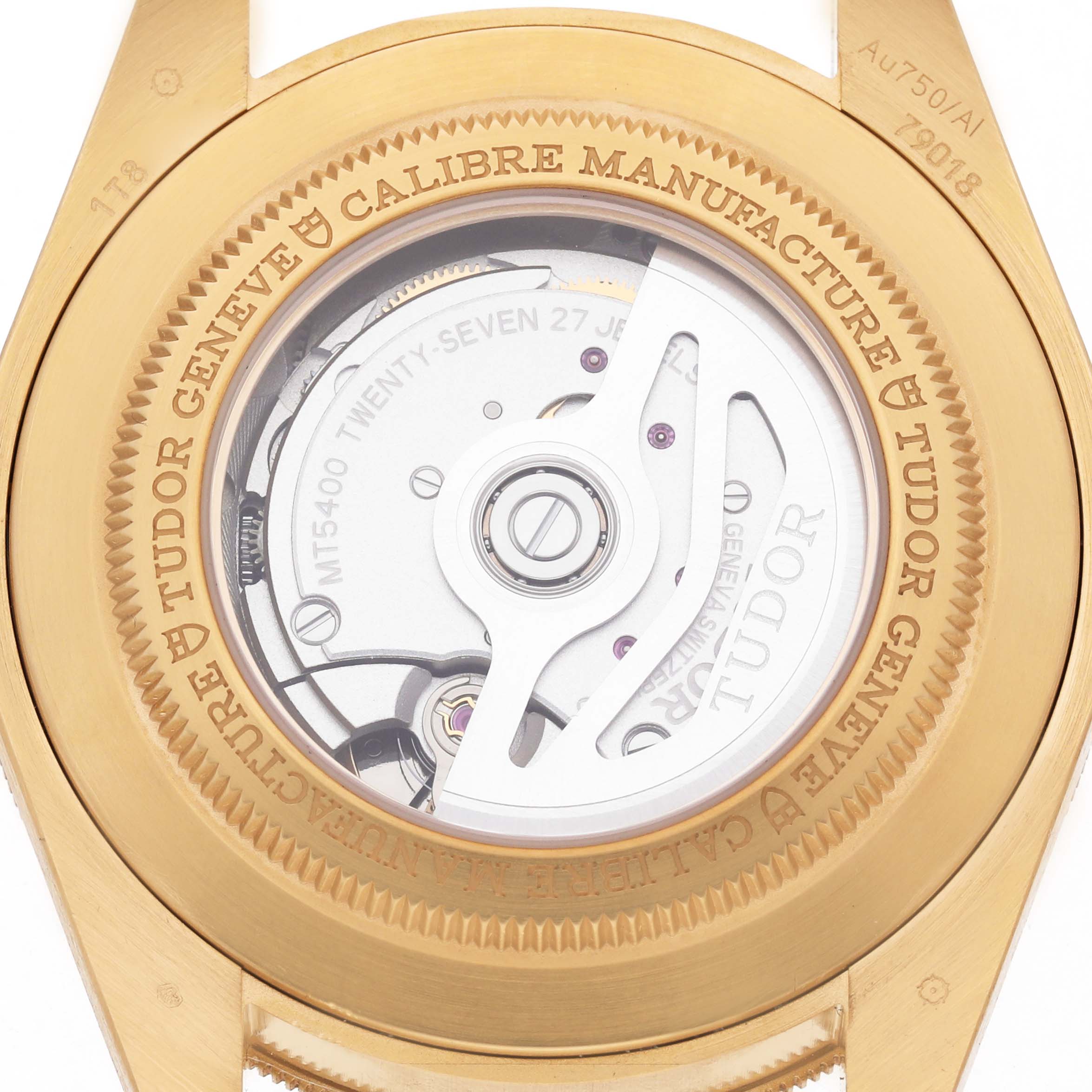 The image shows the case back of a Tudor Heritage Black Bay M79018V-0001 Men's Yellow Gold Green Dial watch, highlighting the internal movement and engravings.