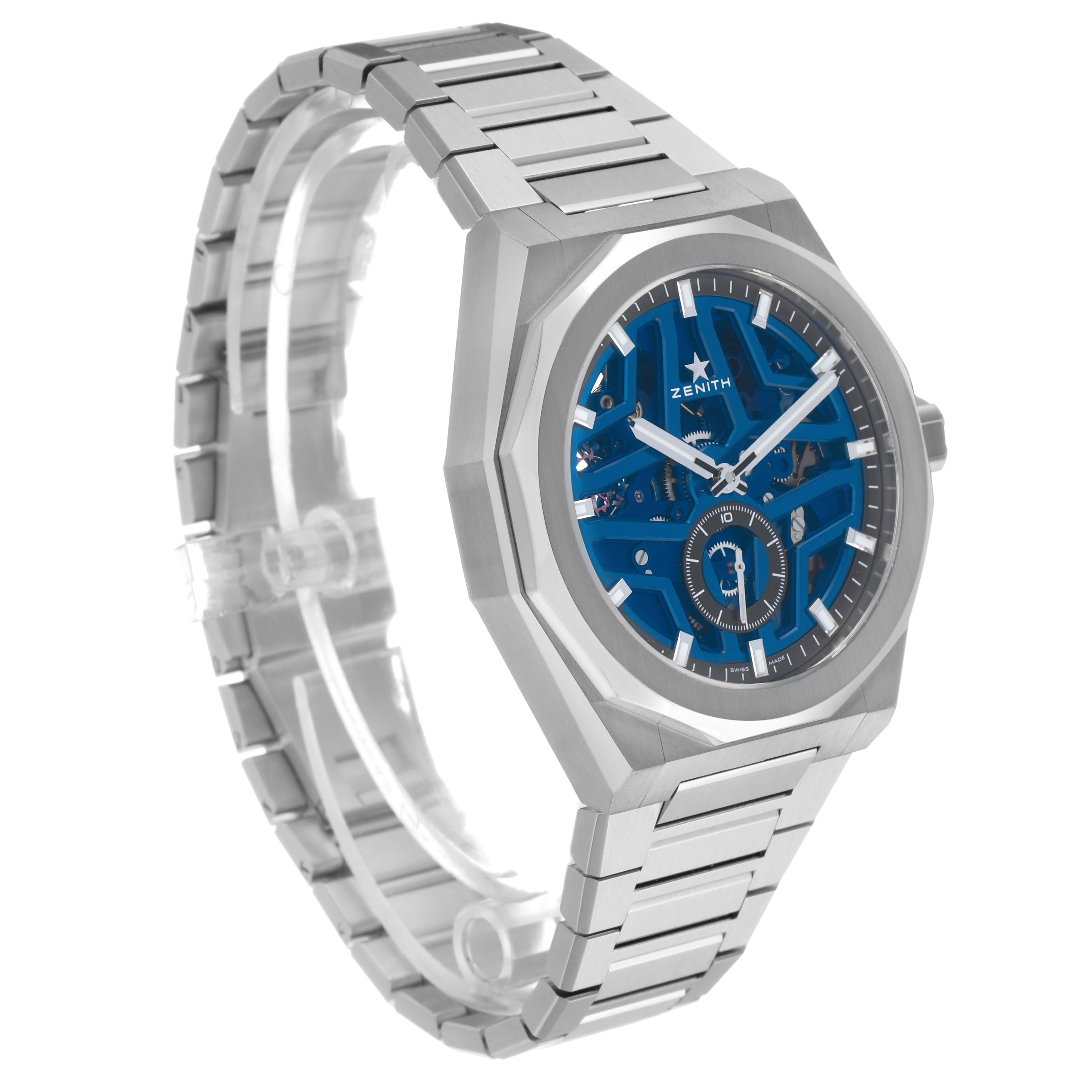 The Zenith Defy 03.9300.3620 Men's Stainless Steel Blue Dial watch is shown at a three-quarter angle, highlighting its blue openwork dial and angular metal bracelet.