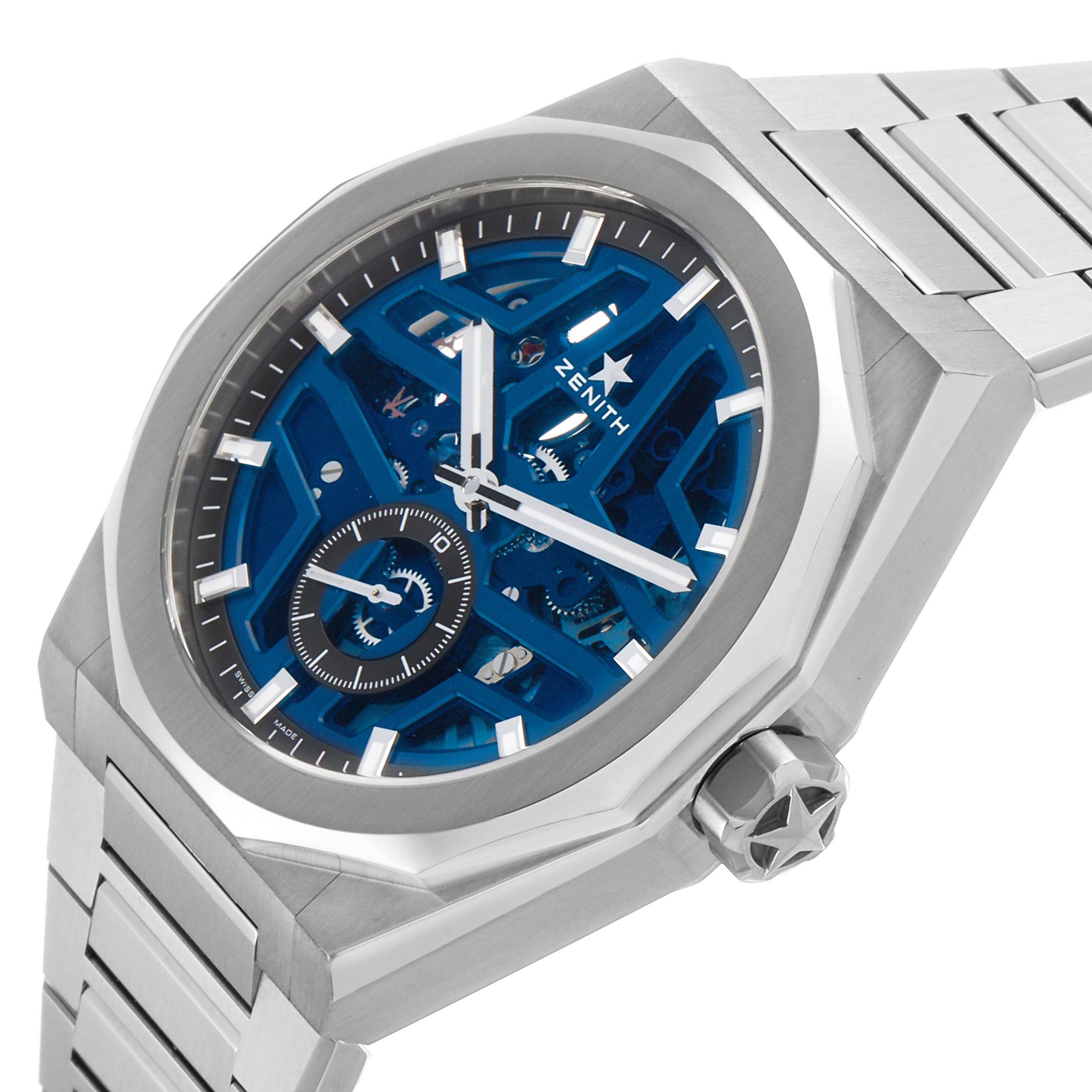 The image shows a Zenith Defy 03.9300.3620 Men's Stainless Steel Blue Dial model watch at an angle, highlighting the blue skeleton dial, stainless steel case, and bracelet.