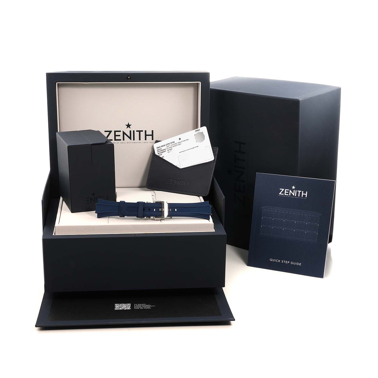 The image shows a Zenith Defy 03.9300.3620 Men's Stainless Steel Blue Dial watch box, strap, card holder, and manual arranged at eye level.