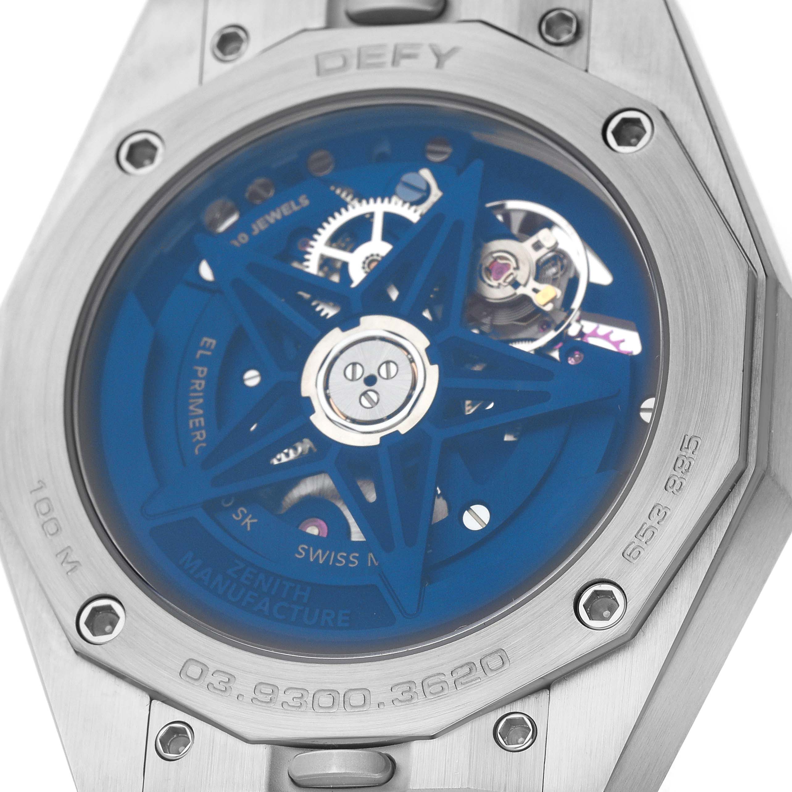 The image shows the back view of the Zenith Defy 03.9300.3620 Men's Stainless Steel Blue Dial watch, highlighting its movement and transparent case back details.