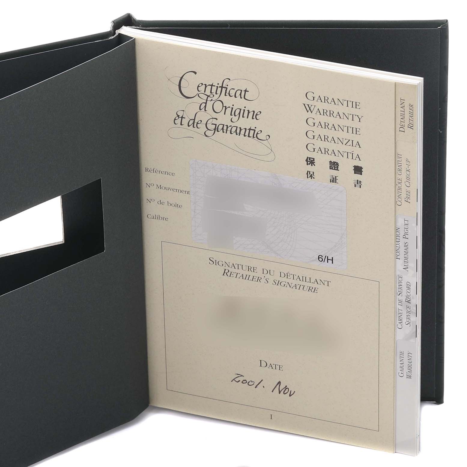 The image shows a certificate booklet for the Royal Oak model by Audemars Piguet, angled open to display warranty and certification pages.