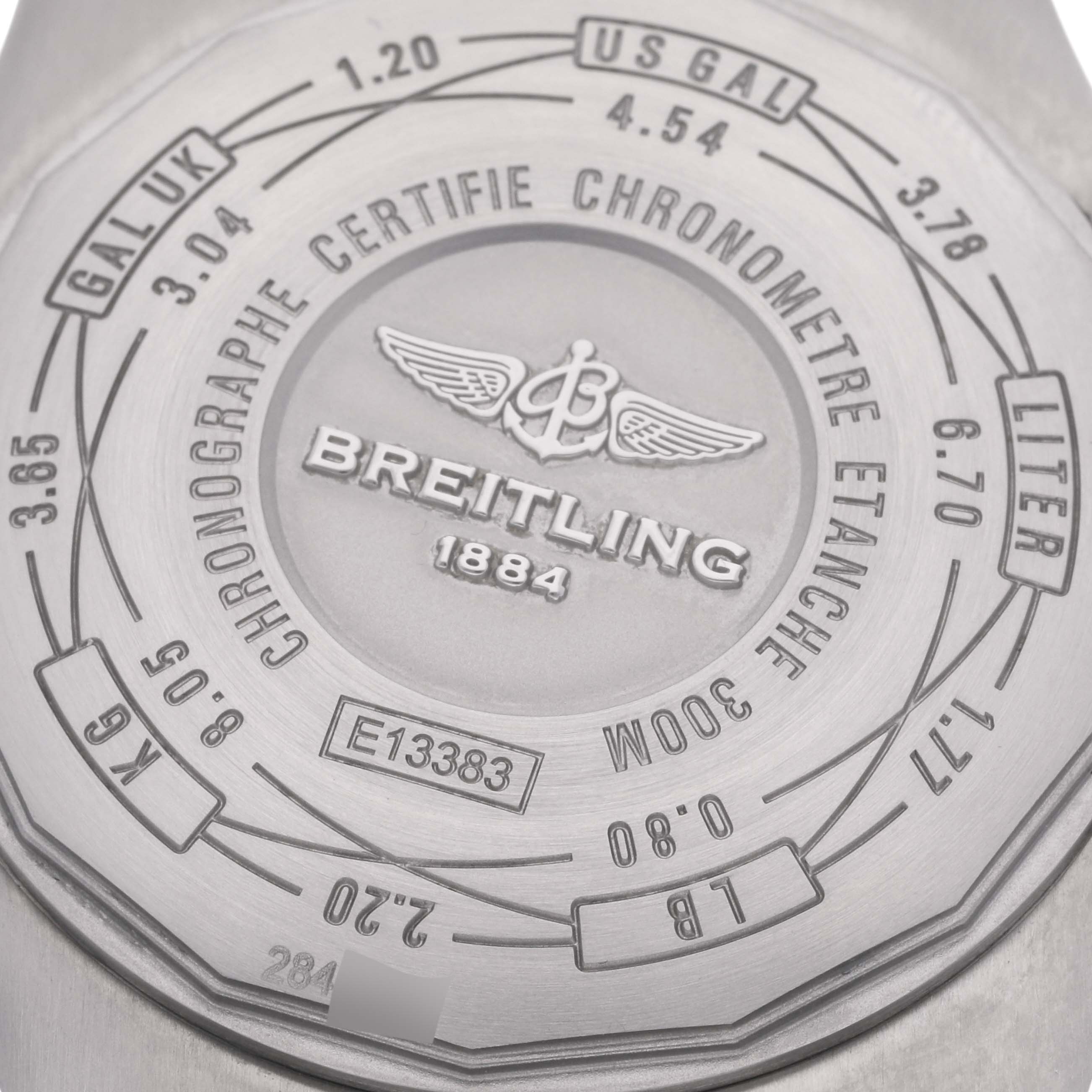 The image shows the back case of the Breitling Avenger E1338310/M536-109W Men's Titanium Grey Dial E1338310/M536-109W Men's Titanium Grey Dial watch, featuring engravings and unit conversions.