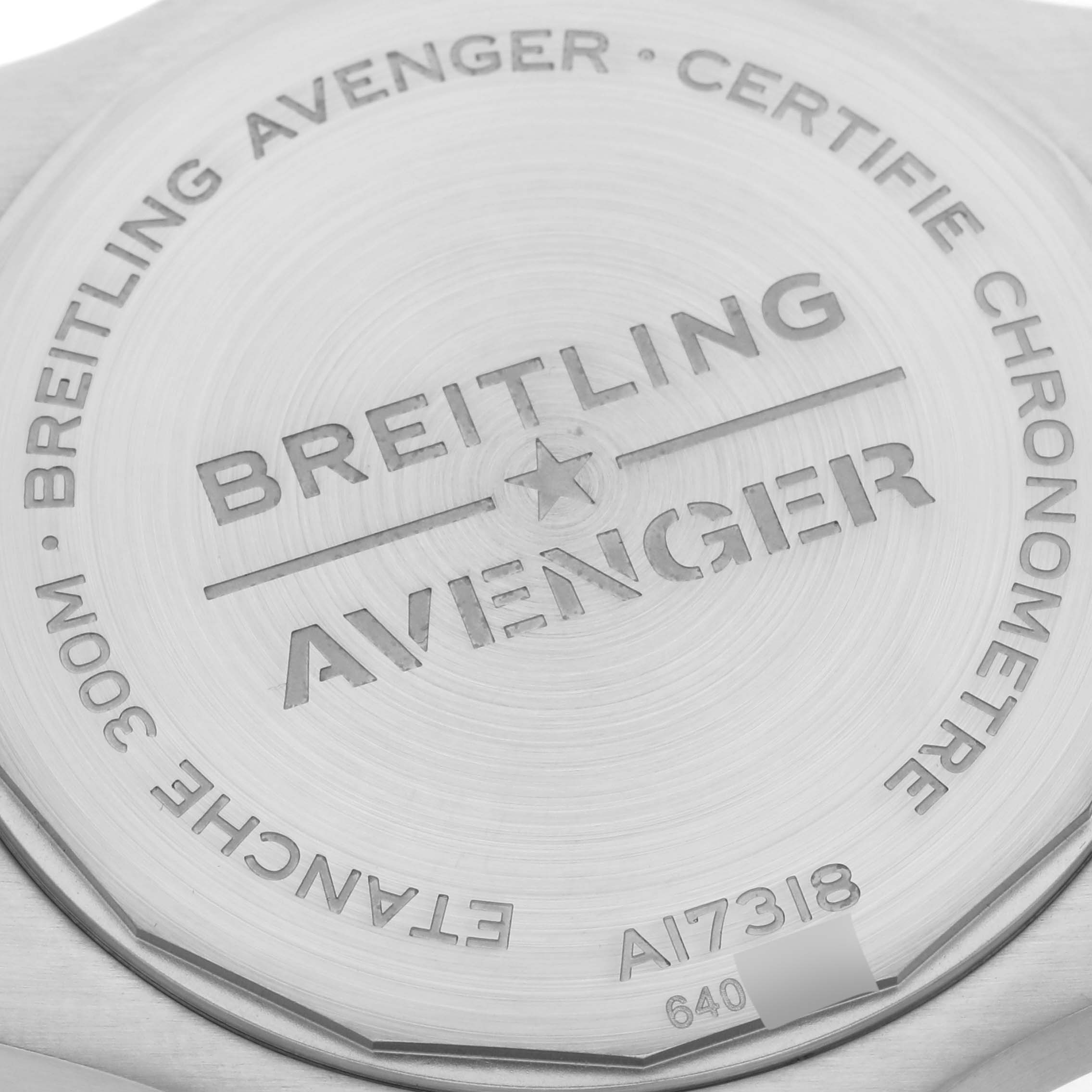 The image shows the back case of a Breitling Avenger A17318 Men's Stainless Steel Black Dial A17318 Men's Stainless Steel Black Dial watch, displaying engravings and model information.