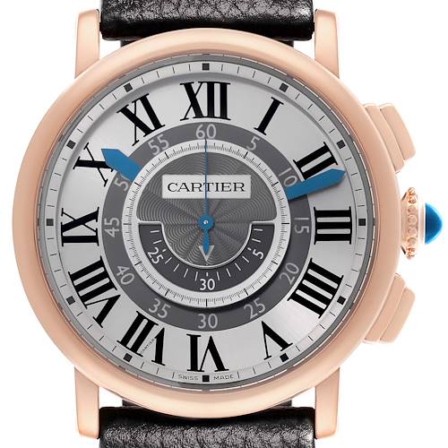 The image shows a front view of the Cartier Rotonde watch, highlighting its dial, Roman numerals, hands, and crown with a blue gem.