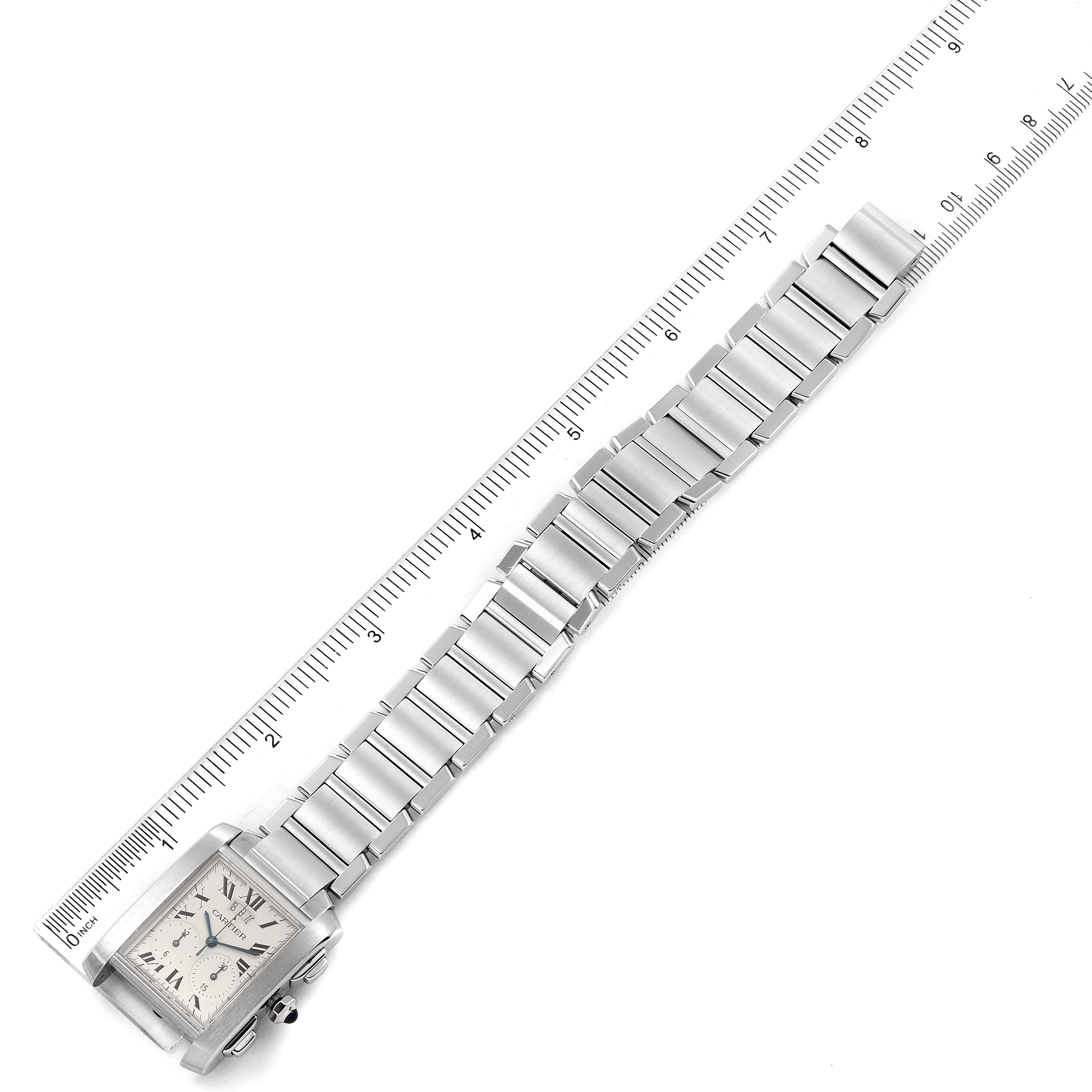 This image shows the Cartier Tank Francaise W51024Q3 Men's Stainless Steel Silver Dial W51024Q3 Men's Stainless Steel Silver Dial watch laid flat, displaying its face and metal bracelet with a ruler for scale.