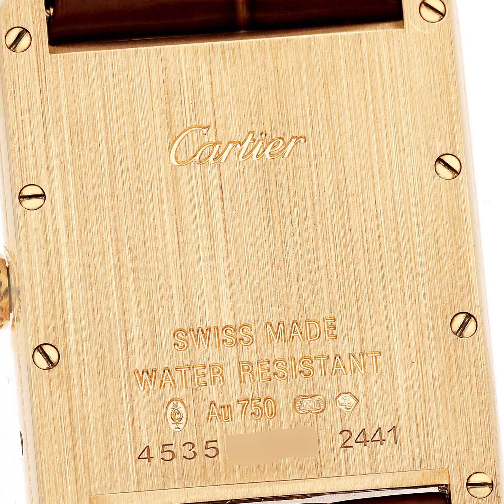 The image shows the back case of a Cartier Tank Louis W1529756 Men's Yellow Gold Silver Dial watch, highlighting its engravings and screws.