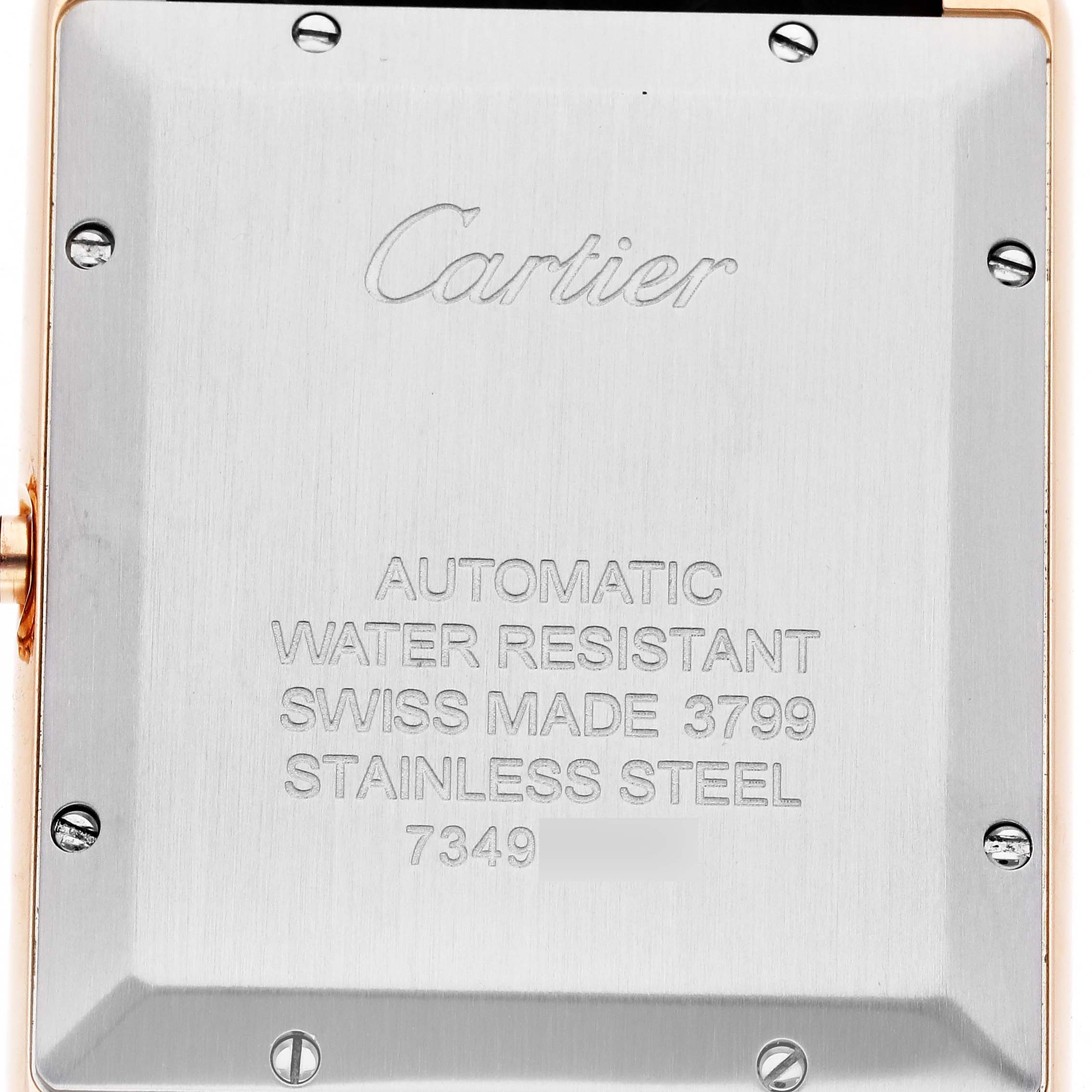 The image shows the back case of the Cartier Tank Solo W5200026 Men's Rose Gold Silver Dial W5200026 Men's Rose Gold Silver Dial watch, highlighting the engraved details and screws.