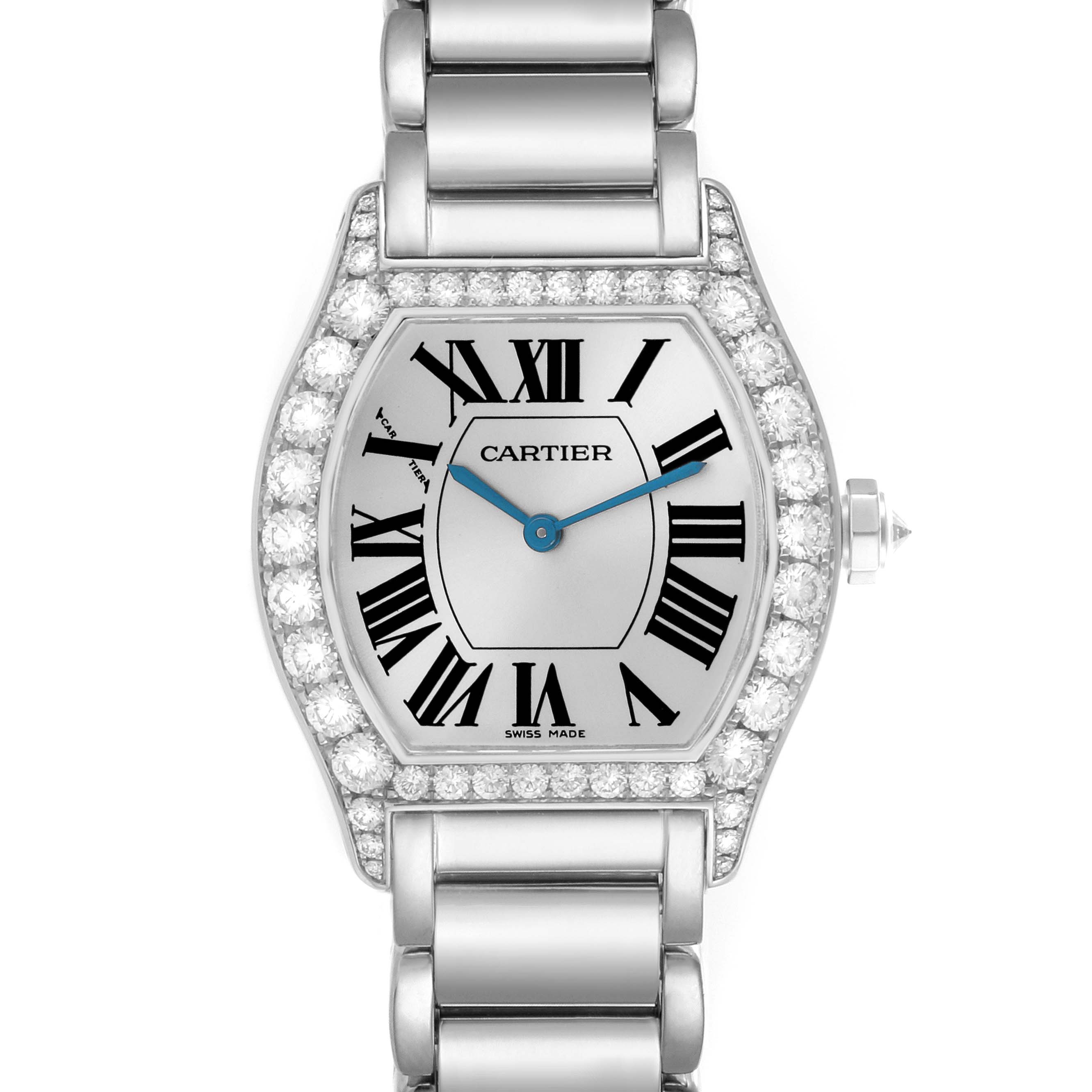 The image shows a frontal view of a Cartier Tortue WA5072W9 Women's White Gold Silver Dial WA5072W9 Women's White Gold Silver Dial watch, highlighting its diamond-studded bezel, Roman numerals, and metal bracelet.