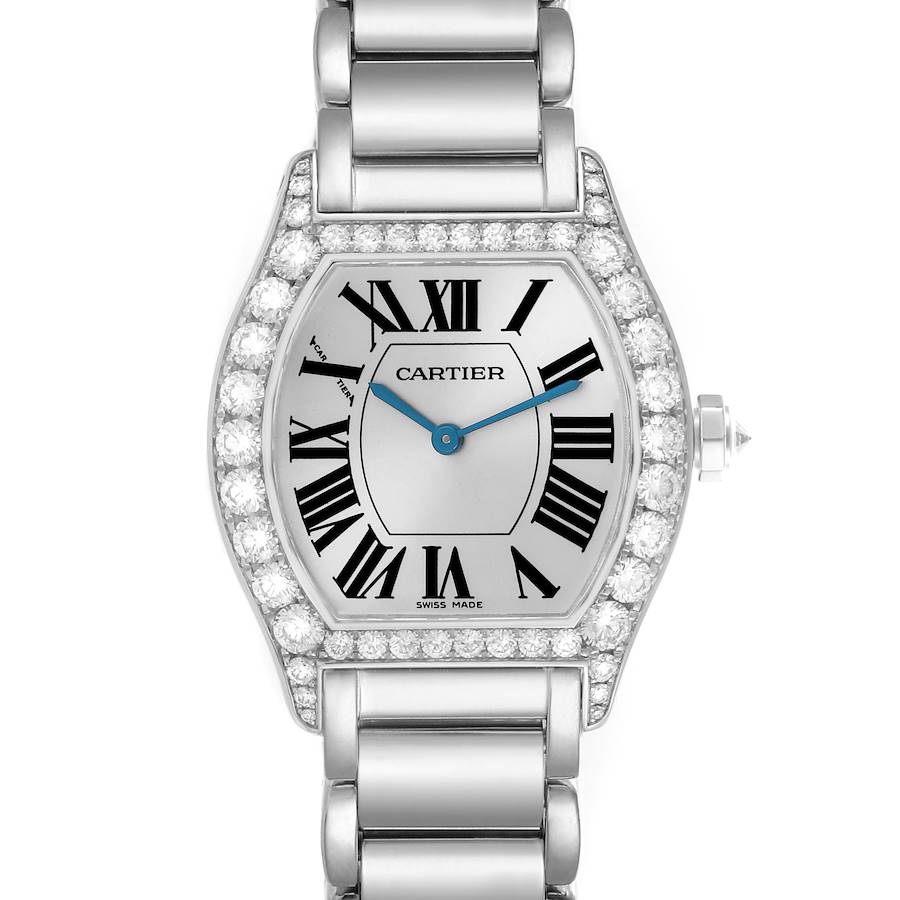 The image shows a frontal view of a Cartier Tortue watch, highlighting its diamond-studded bezel, Roman numerals, and metal bracelet.