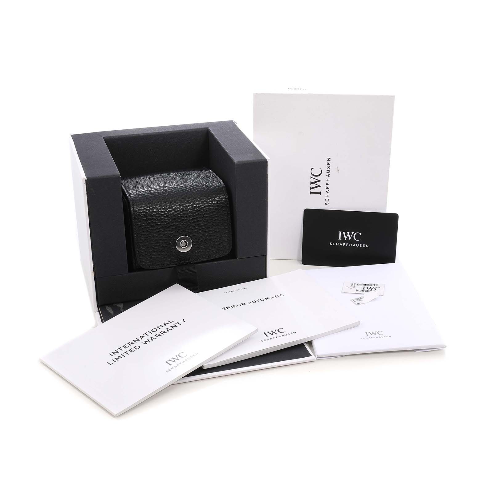 The image shows the box and accessories for the IWC Ingenieur IW328901 Men's Stainless Steel Black Dial watch, including a black case, warranty, and manuals.