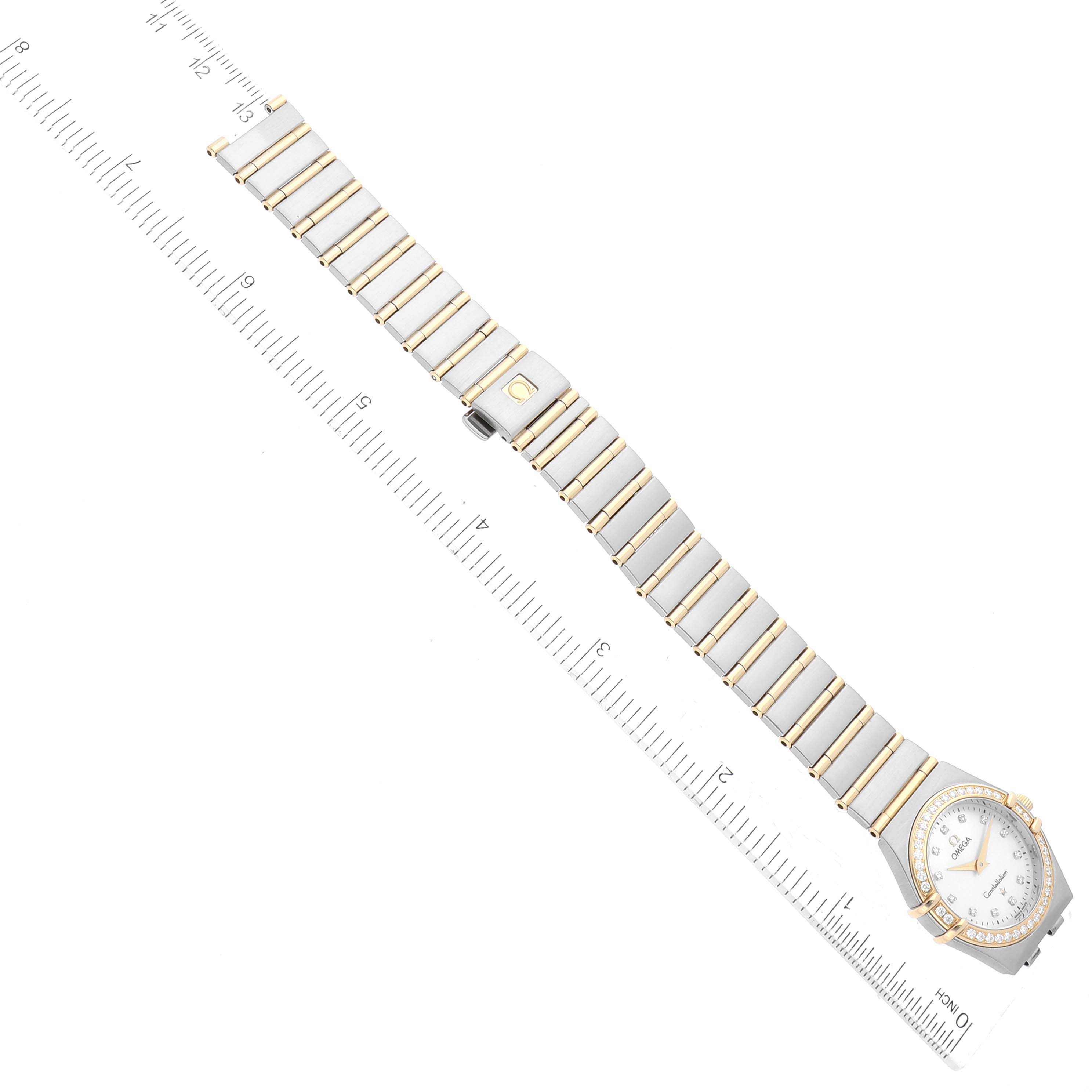 The Omega 1277.75.00 Women's Steel and Gold (two tone) Mother of Pearl Dial 1277.75.00 Women's Steel and Gold (two tone) Mother of Pearl Dial Constellation 95 model 1277.75.00 watch is shown in full view, lying flat with a ruler for scale.