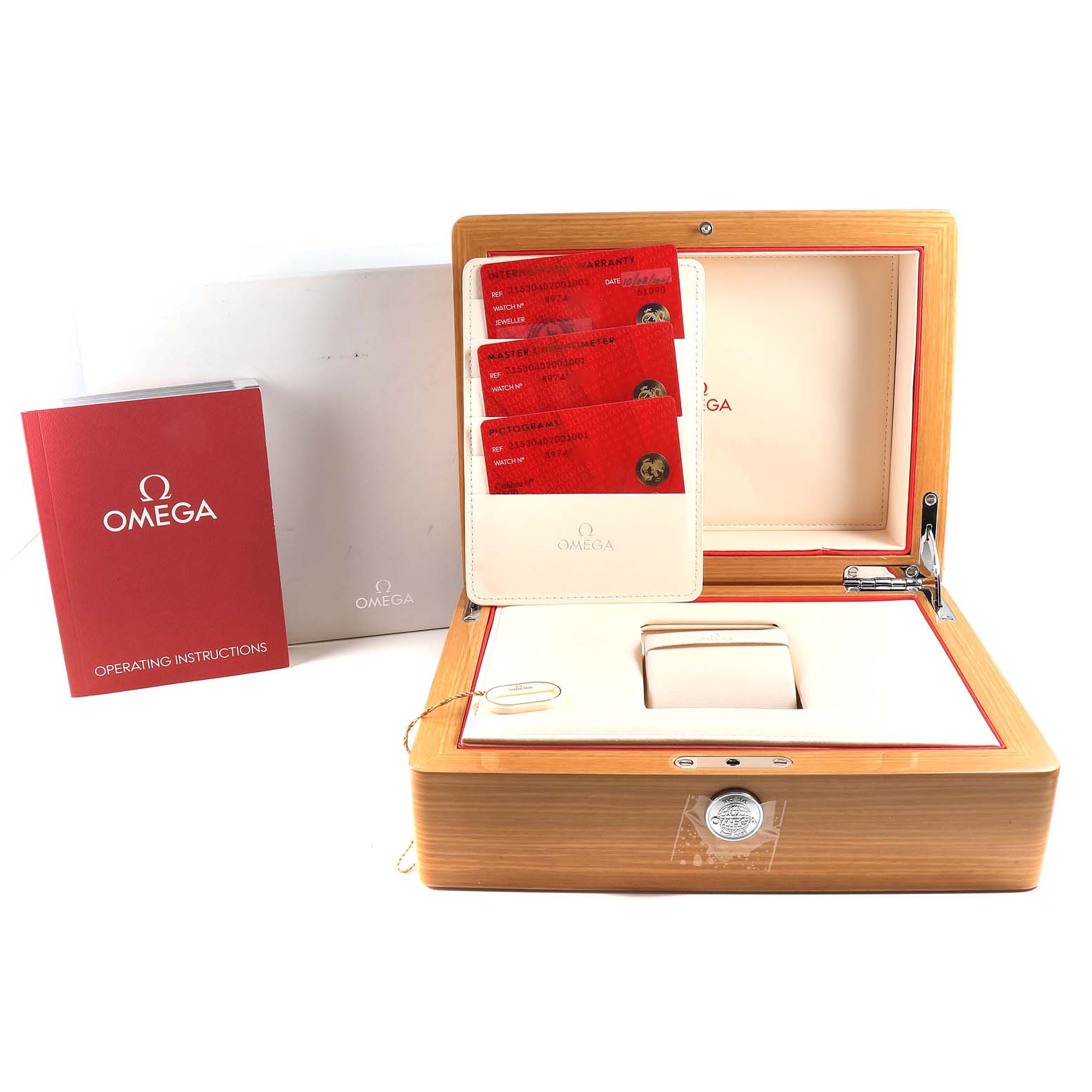 The image shows the packaging and accessories of the Omega Planet Ocean 215.30.40.20.01.001 Men
s Stainless Steel Black Dial 215.30.40.20.01.001 Men
s Stainless Steel Black Dial watch, including the box, instructions manual, and warranty cards.