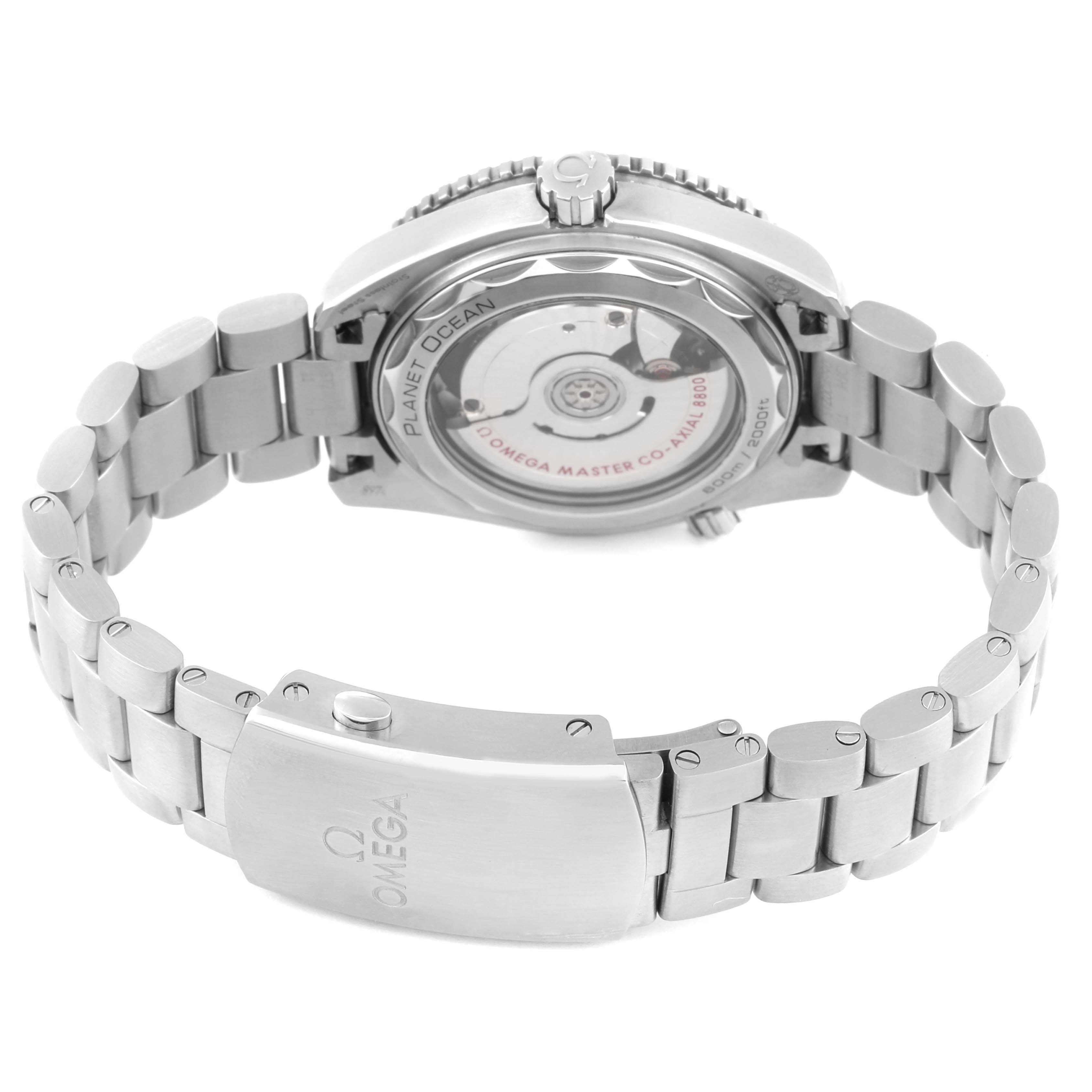 The image shows the back view of the Omega Planet Ocean 215.30.40.20.01.001 Men
s Stainless Steel Black Dial 215.30.40.20.01.001 Men
s Stainless Steel Black Dial model, highlighting the transparent case back and metal bracelet clasp.