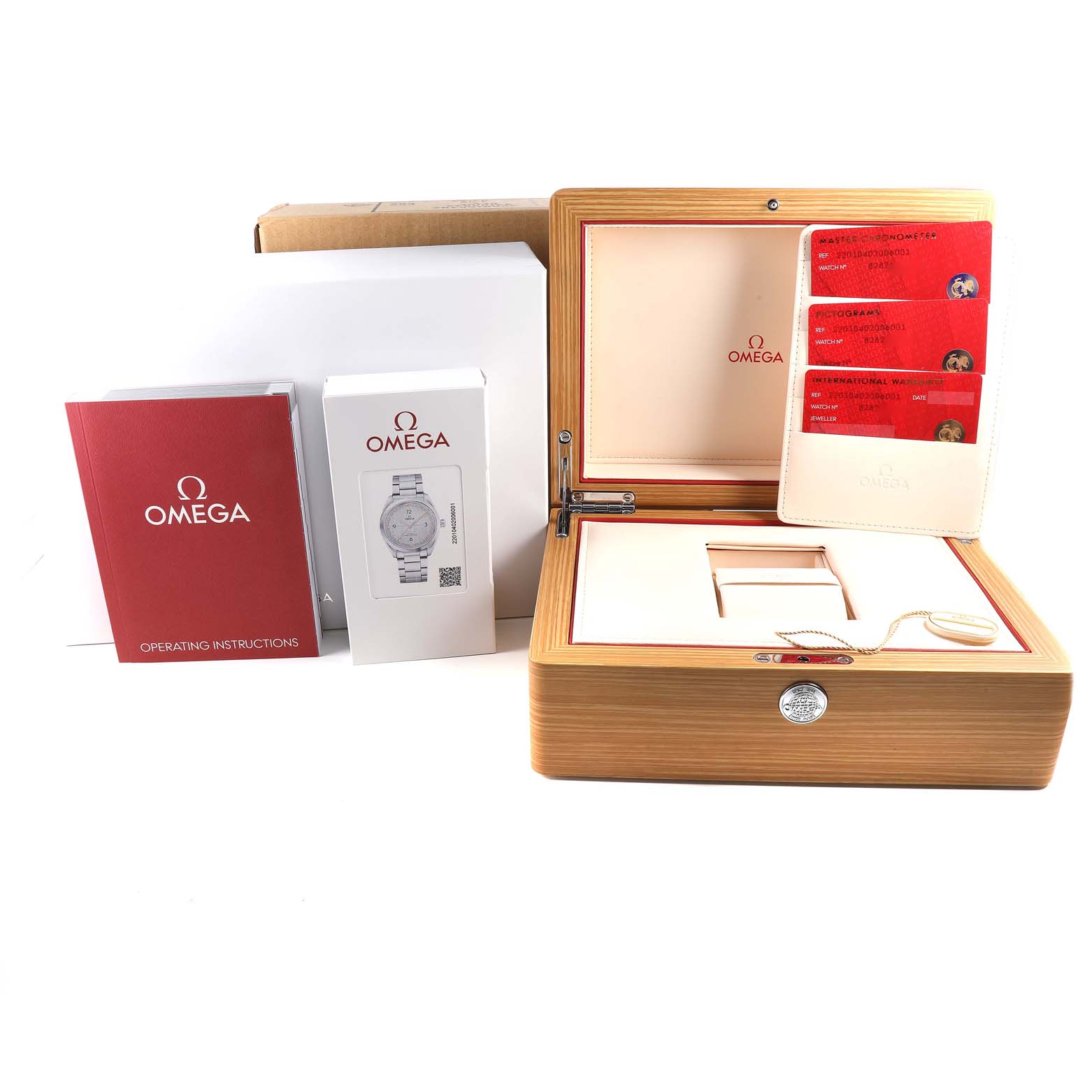 The image shows an Omega Seamaster 220.10.40.20.06.001 Men
s Stainless Steel Grey Dial 220.10.40.20.06.001 Men
s Stainless Steel Grey Dial watch box with its accessories, including the operating instructions, warranty cards, and outer packaging.