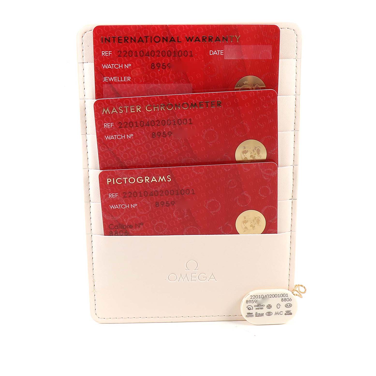 This image shows the accessory cards and holder for an Omega Seamaster 220.10.40.20.01.001 Men
s Stainless Steel Black Dial 220.10.40.20.01.001 Men
s Stainless Steel Black Dial watch, including international warranty, master chronometer, and pictogram cards.