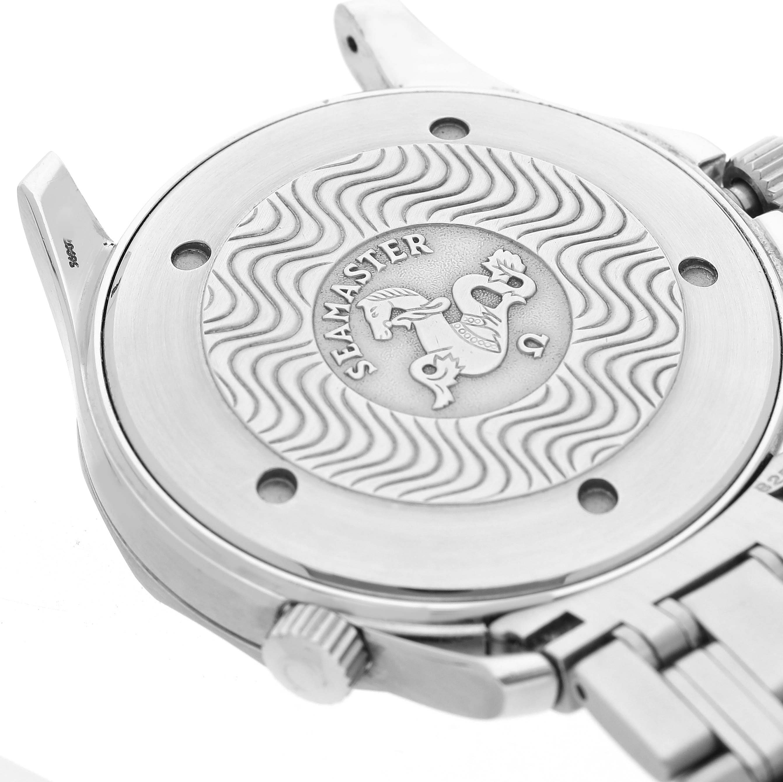 The image shows the case back of an Omega Seamaster 2542.22.00 Men's Stainless Steel White Dial watch, highlighting its engraved wave pattern and emblem.