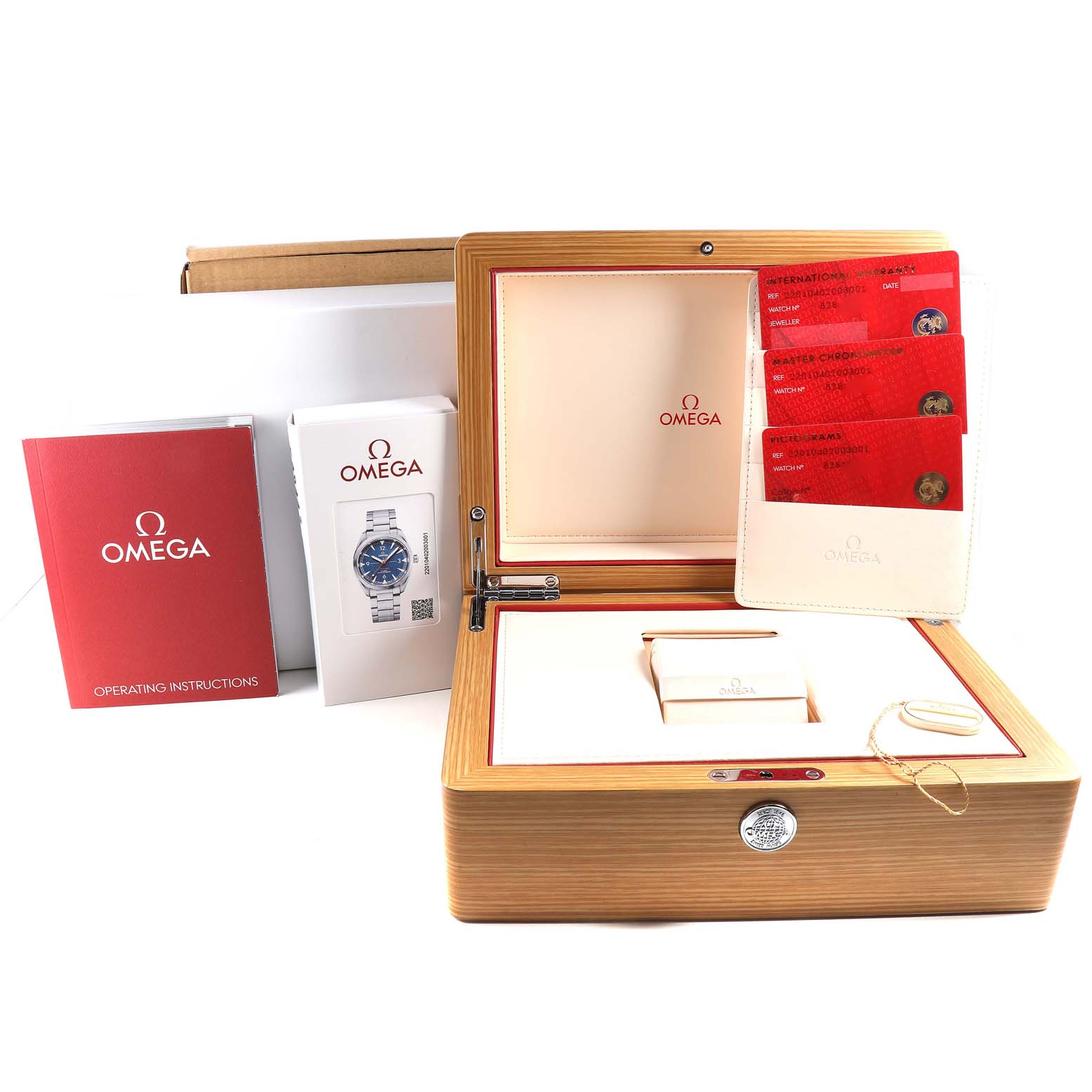 The image shows the packaging, documentation, and accessories of an Omega Seamaster 220.10.40.20.03.001 Men
s Stainless Steel Blue Dial 220.10.40.20.03.001 Men
s Stainless Steel Blue Dial watch, including a wooden box, instruction manual, and warranty cards.