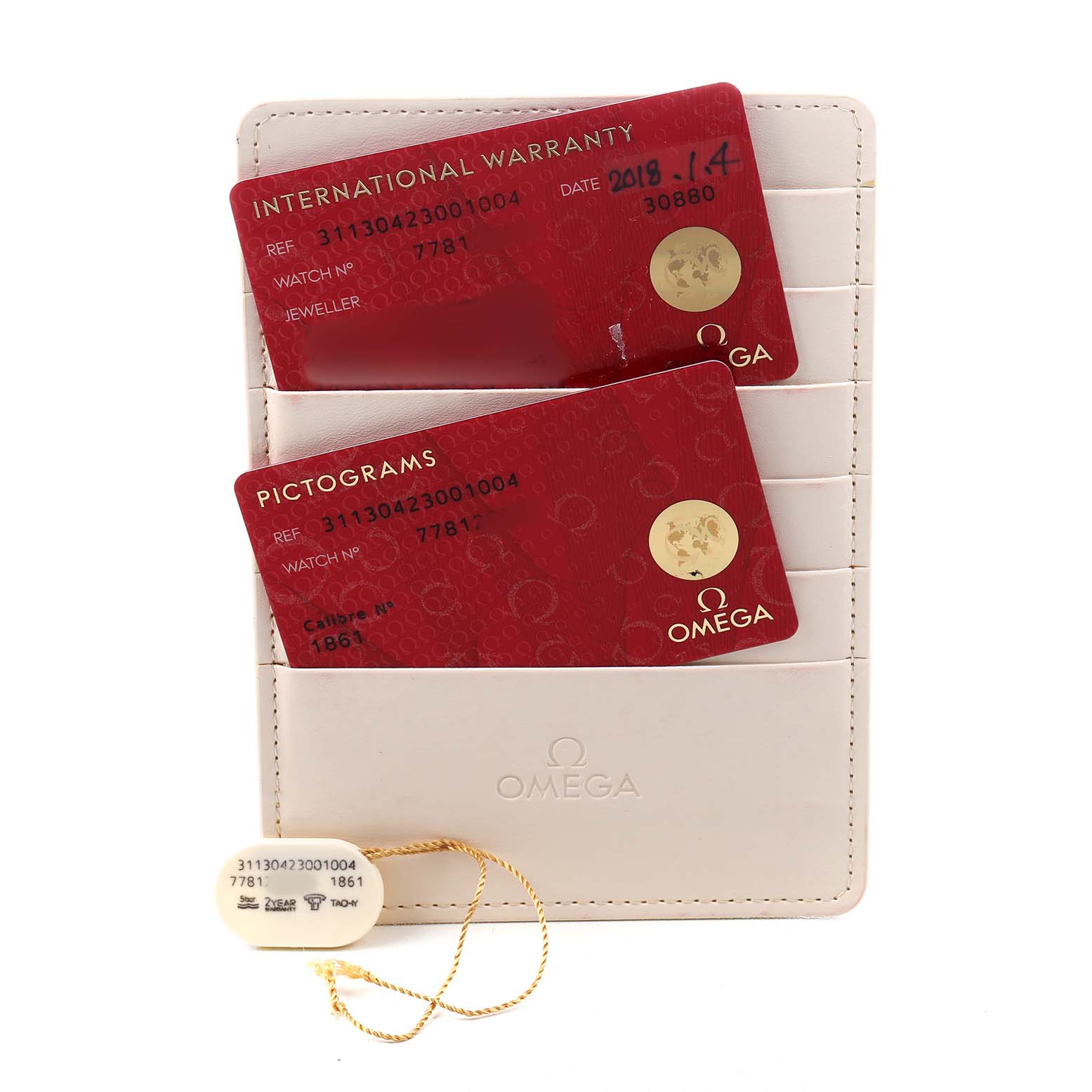 The image shows the Omega Speedmaster 311.30.42.30.01.004 Men's Stainless Steel Black Dial's warranty cards and a tag displayed on a white card holder.