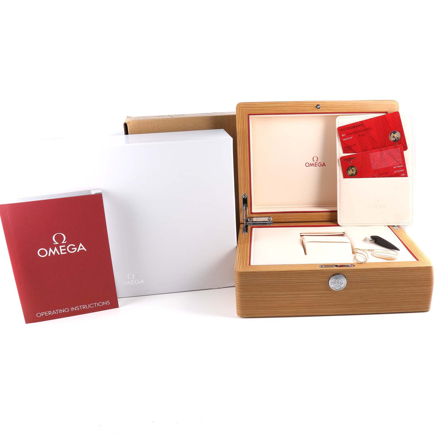 The image shows an opened wooden Omega Speedmaster 326.30.40.50.01.002 Men
s Stainless Steel Black Dial 326.30.40.50.01.002 Men
s Stainless Steel Black Dial watch box with cards, a keychain, an operation manual, and a white outer box.