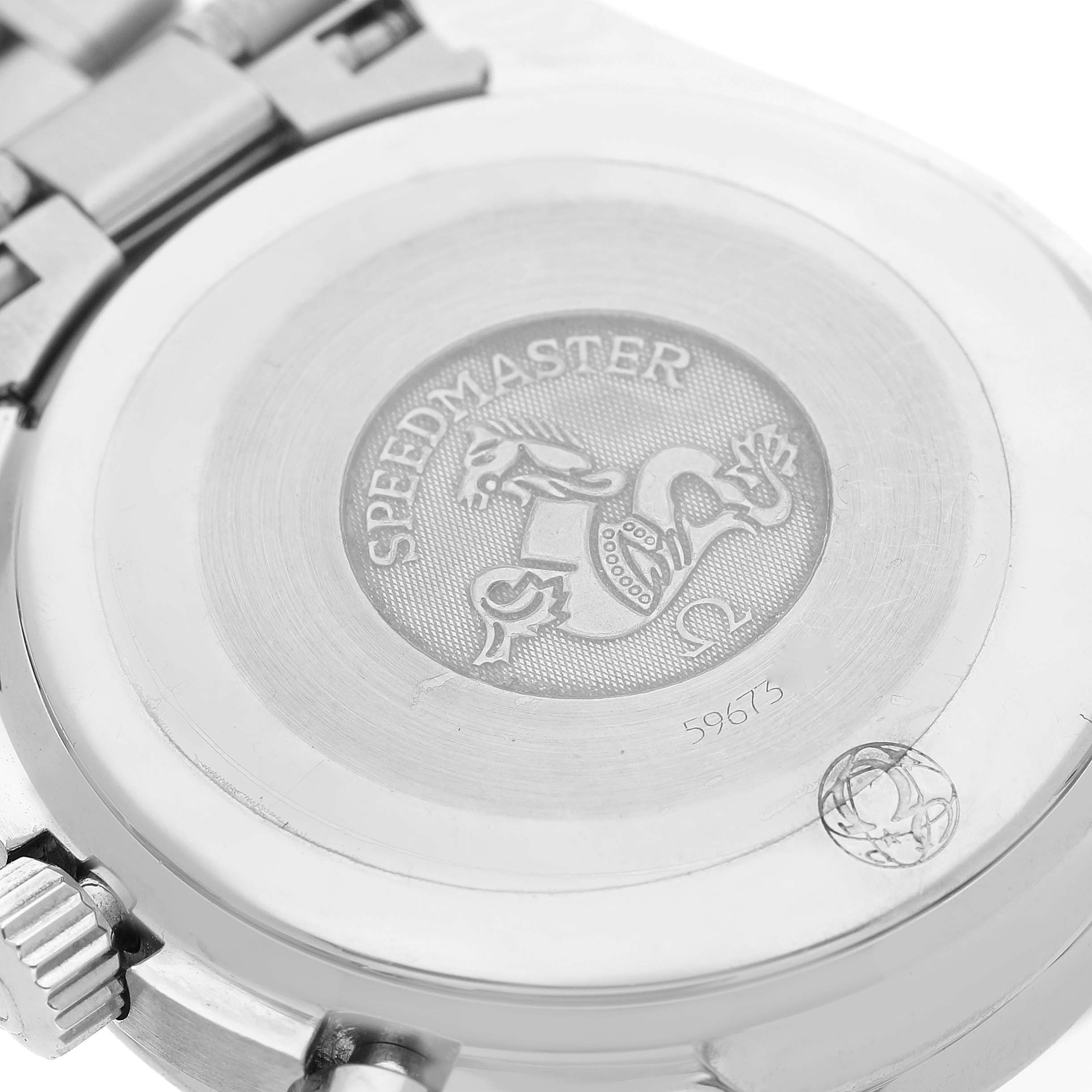 The image shows the case back of an Omega Speedmaster 3539.50.00 Men
s Stainless Steel Black Dial 3539.50.00 Men
s Stainless Steel Black Dial watch, with intricate engravings and part of the metal bracelet visible.