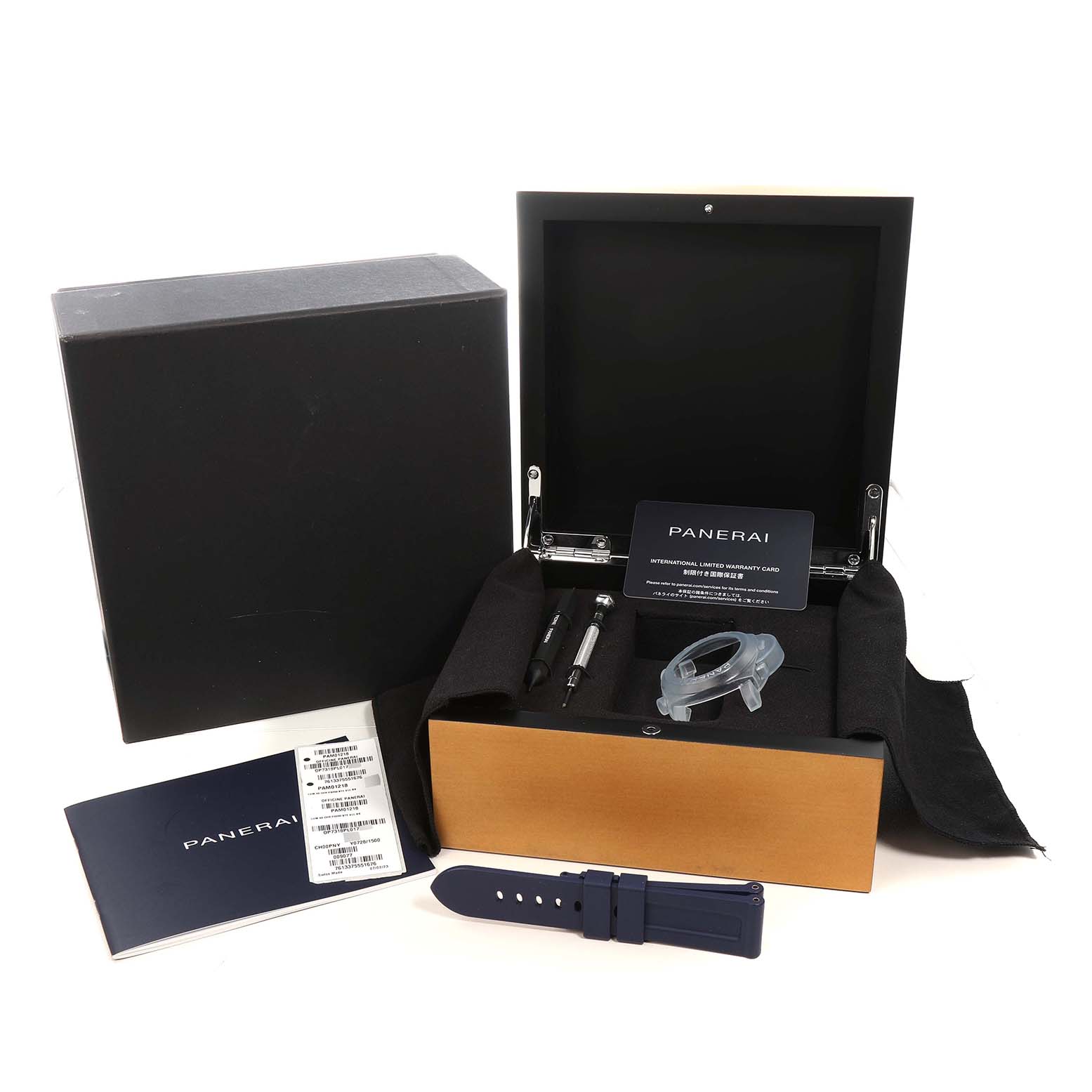 The image shows a Panerai Luminor PAM01218 Men's Stainless Steel White Dial watch box, warranty card, tools, strap, and protective cover from a front angle.