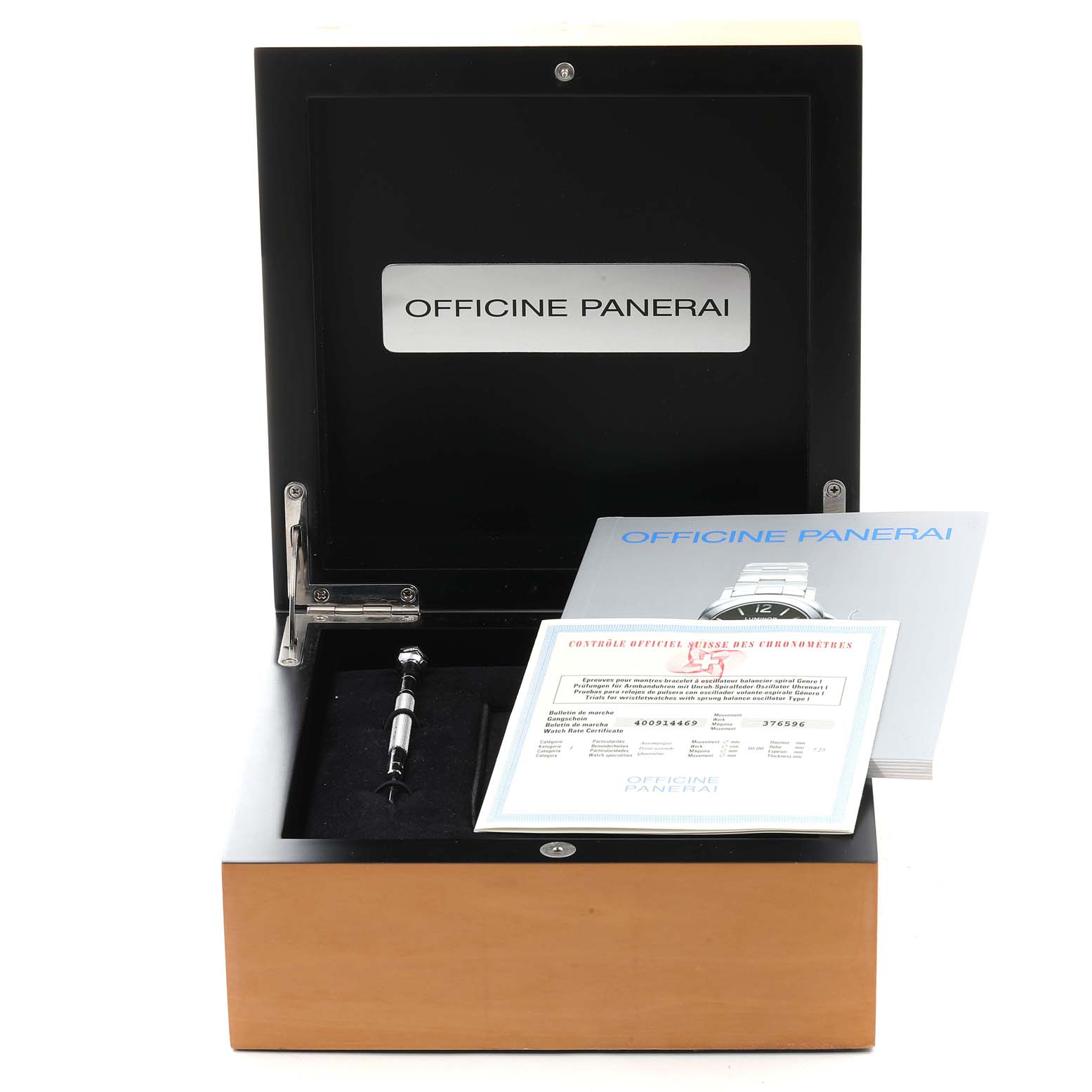 The image shows a Panerai Luminor PAM00104 Men
s Stainless Steel Black Dial PAM00104 Men
s Stainless Steel Black Dial watch box containing documents and a tool, viewed from a front angle.