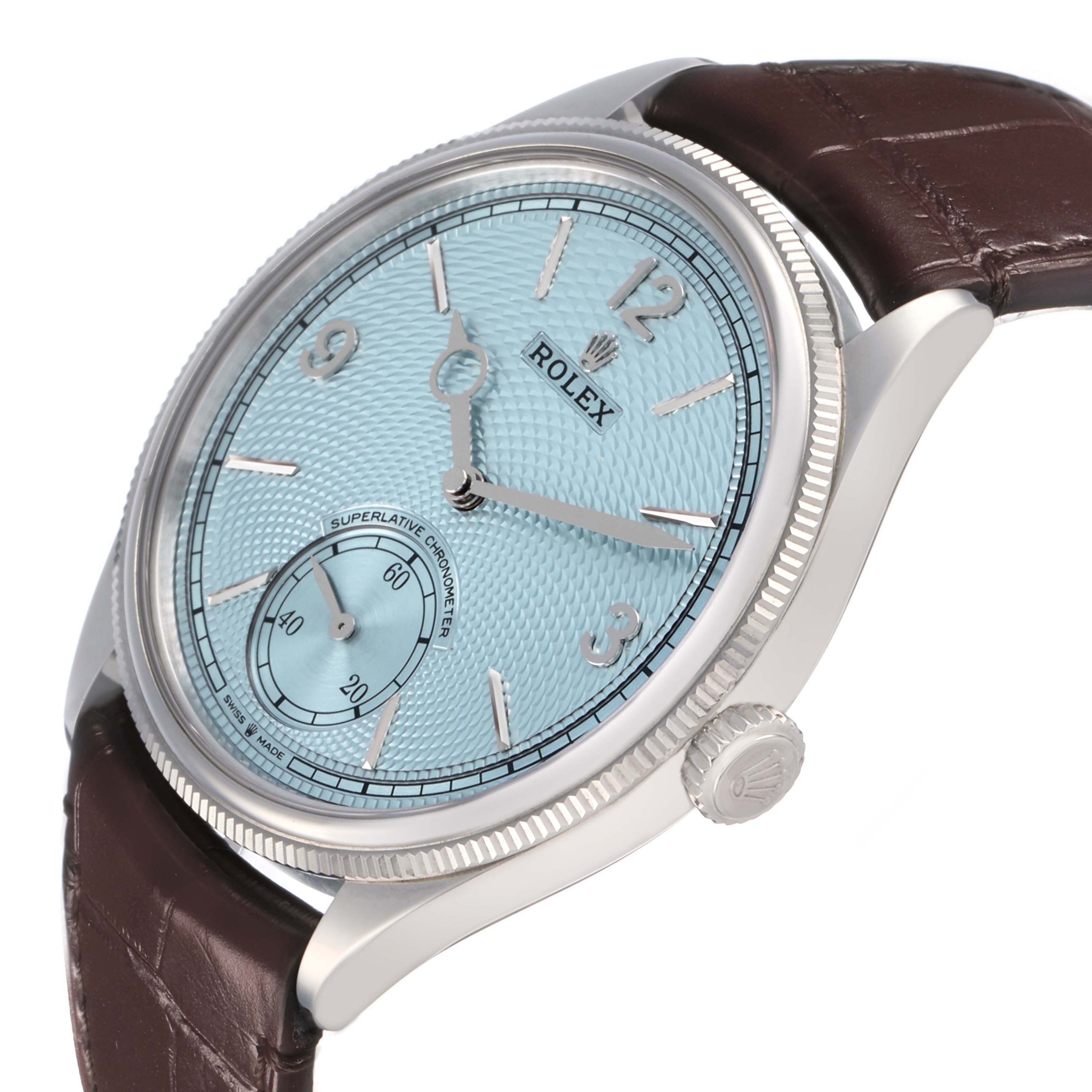 The image shows a side angle of the Rolex 1908 52506 Men's Platinum Blue Dial model, highlighting the blue dial, silver indices, and brown leather strap.