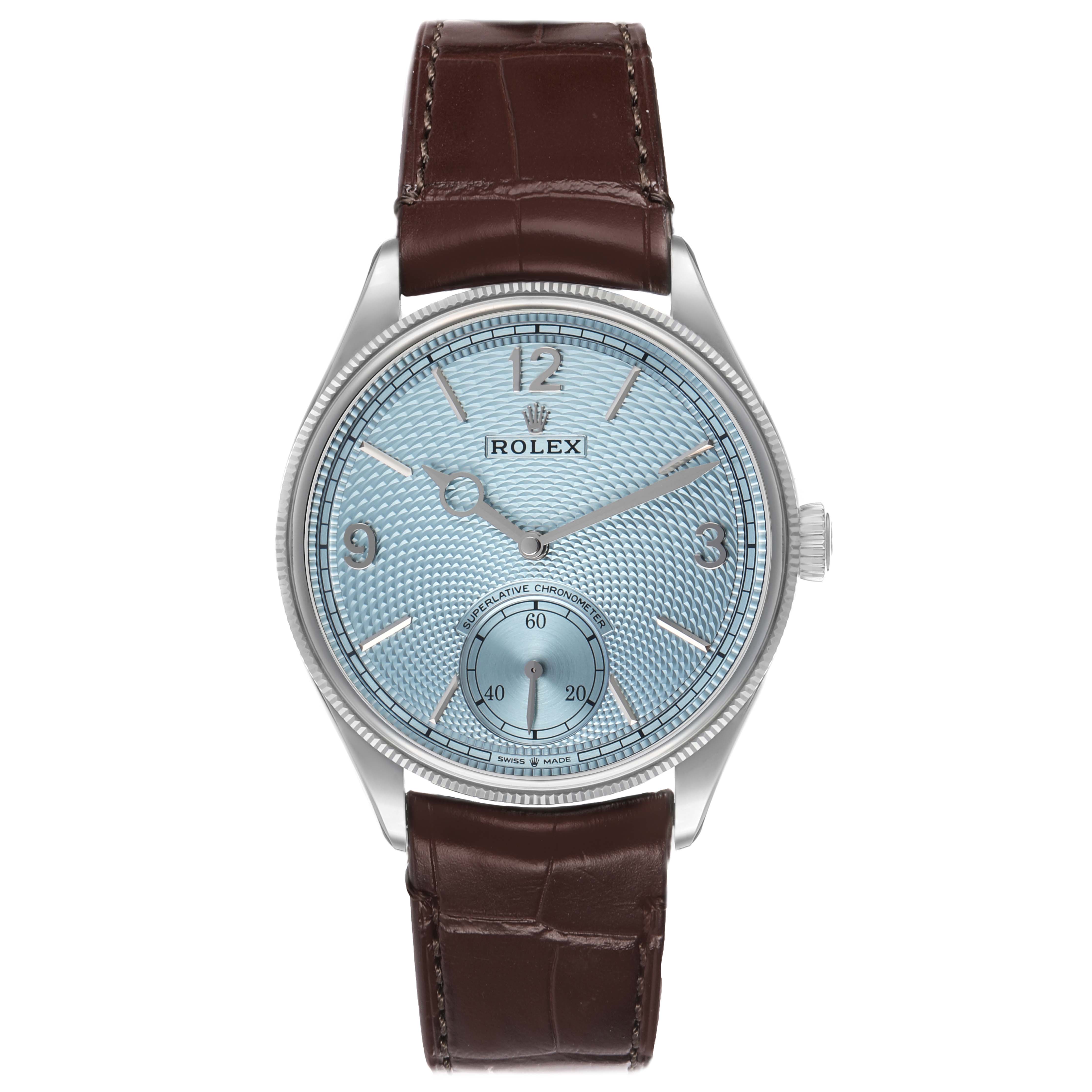 The Rolex 1908 52506 Men's Platinum Blue Dial watch is shown from a front angle, highlighting its face, bezel, and brown leather strap.