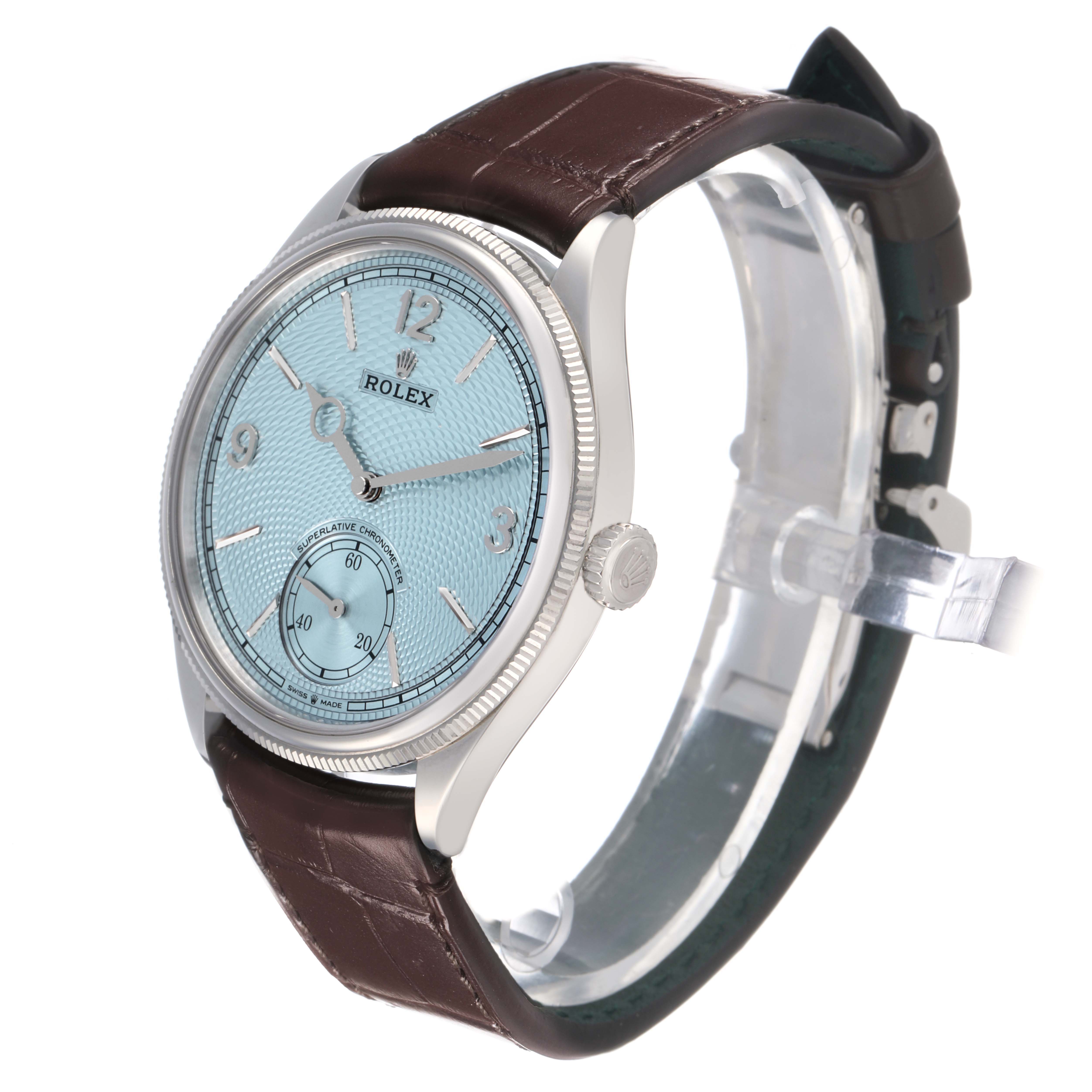 The Rolex 1908 52506 Men's Platinum Blue Dial model is shown from a front angle, highlighting the face, bezel, crown, and part of the leather strap.