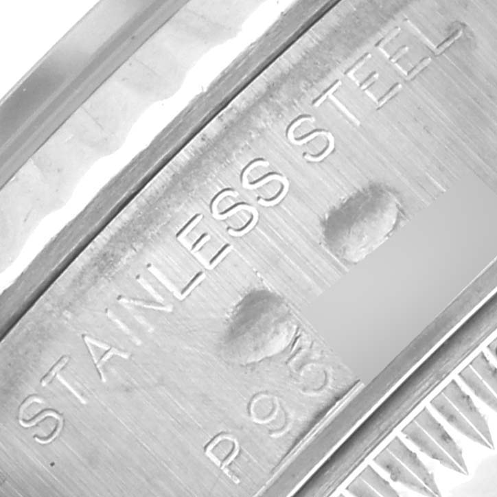 The image shows a close-up of the stainless steel engraving on the side of a Rolex Datejust 79174 Women's Stainless Steel Mother of Pearl Dial 79174 Women's Stainless Steel Mother of Pearl Dial watch case.