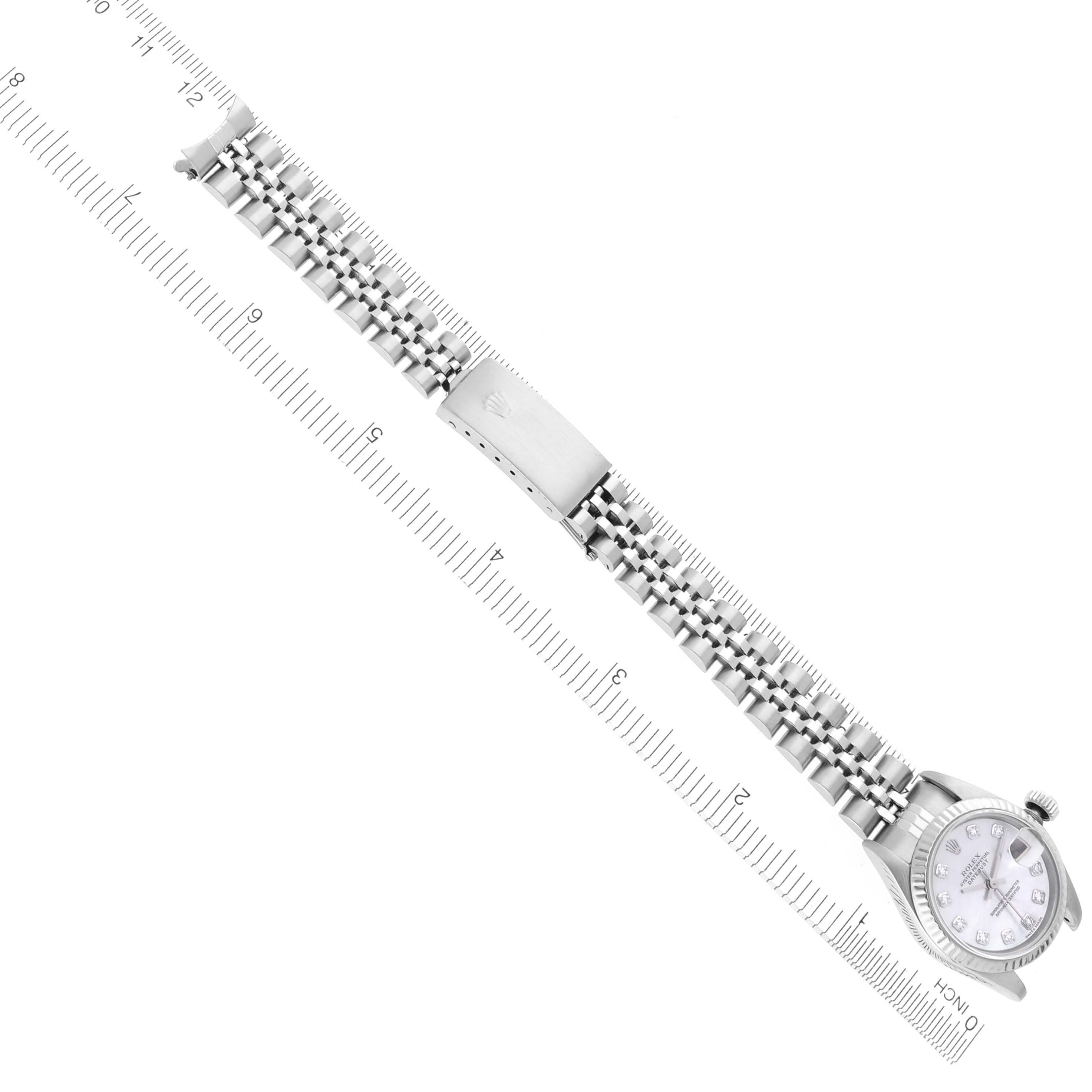 The image shows a Rolex Datejust 79174 Women's Stainless Steel Mother of Pearl Dial 79174 Women's Stainless Steel Mother of Pearl Dial watch laid out flat with its bracelet extended, alongside a ruler for scale.