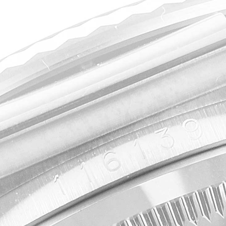 The image shows a macro view of the bezel and case of a Rolex Datejust 116139 Men's White Gold Black Dial 116139 Men's White Gold Black Dial watch.