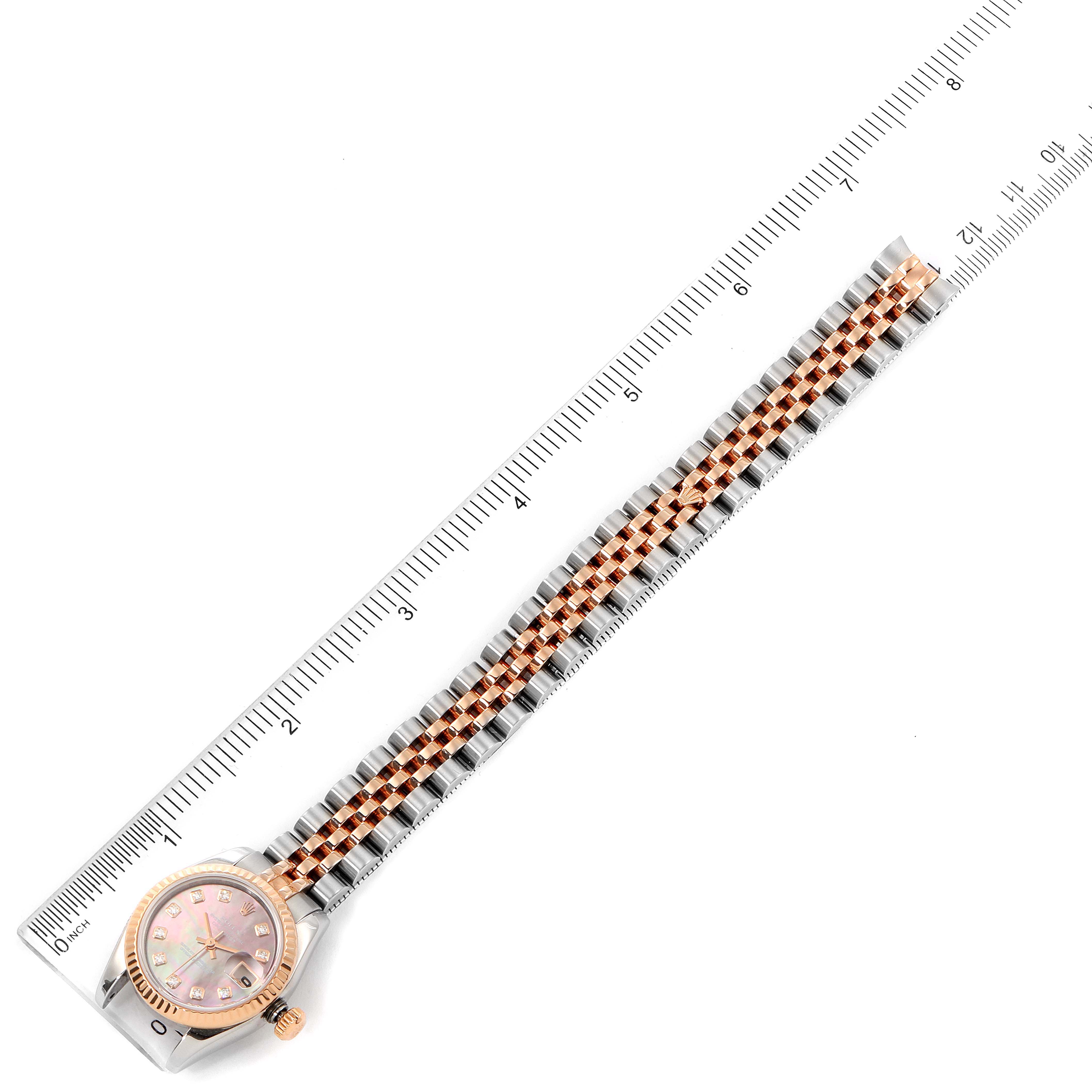 The Rolex Datejust 179171 Women's Steel and Gold (two tone) Mother of Pearl Dial 179171 Women's Steel and Gold (two tone) Mother of Pearl Dial watch is shown from a top view, along with a measuring ruler; only the face and bracelet are visible.