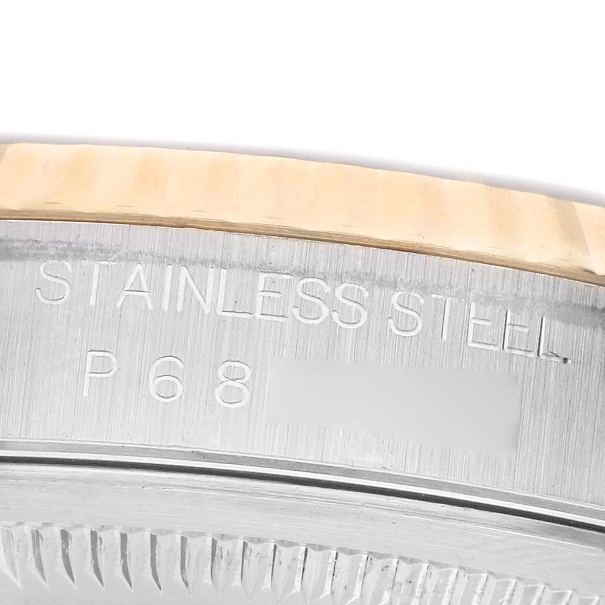 The image shows a close-up of the side of a Rolex Datejust 16233 Men's Steel and Gold (two tone) Silver Dial, highlighting the engraved stainless steel text and part of the bezel.