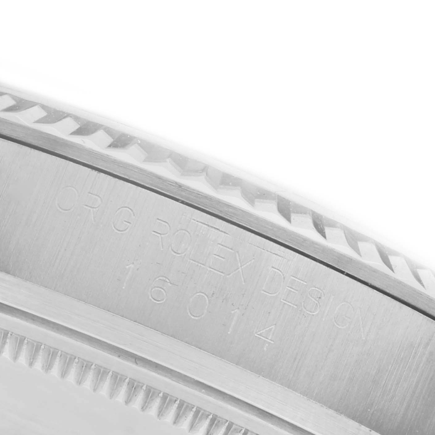 The image shows a close-up of the side of a Rolex Datejust 16014 Men's Stainless Steel Silver Dial 16014 Men's Stainless Steel Silver Dial, highlighting the model number engraving and fluted bezel.