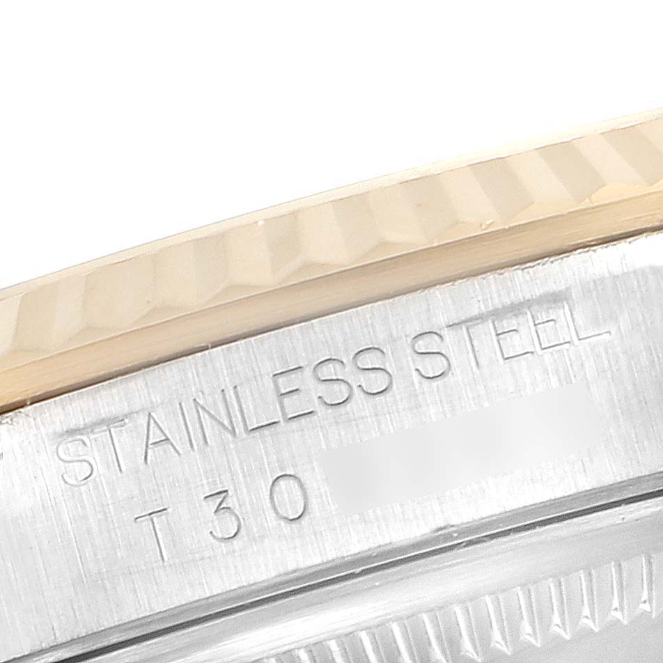 This is a close-up angle showing the bezel and stainless steel case back with engravings on a Rolex Datejust 16233 Men's Steel and Gold (two tone) Champagne Dial 16233 Men's Steel and Gold (two tone) Champagne Dial watch.