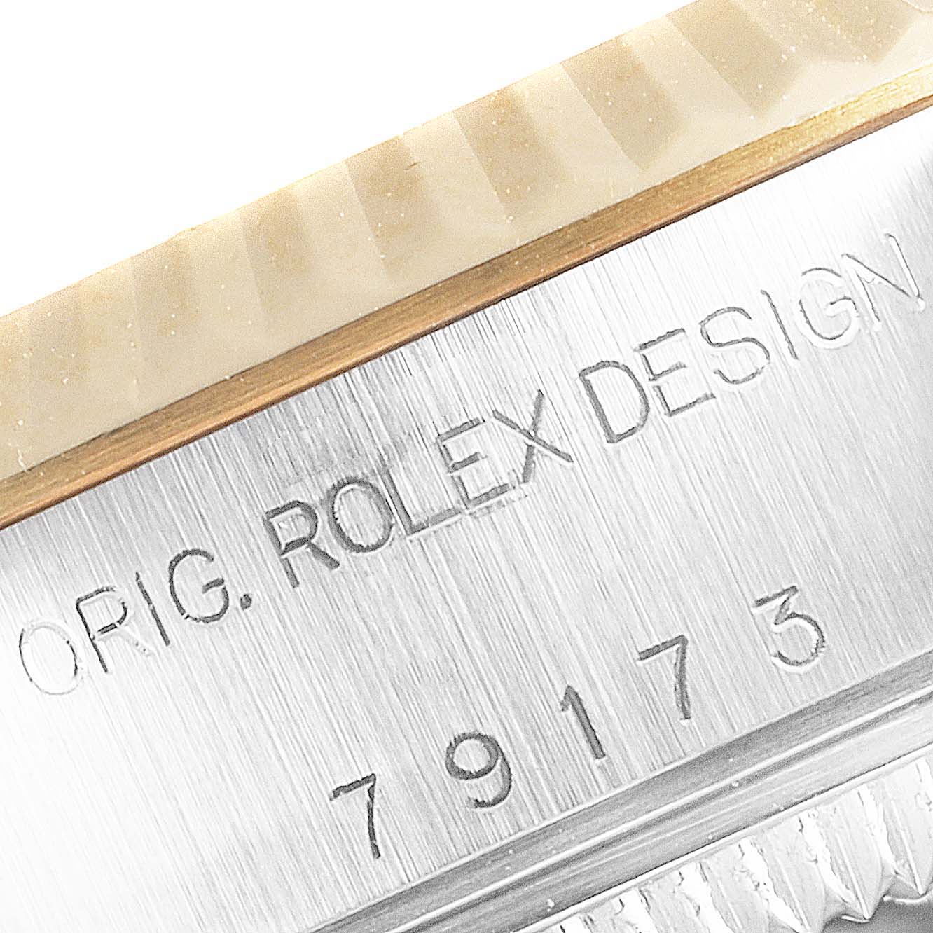 This image shows a close-up of the casing and reference number of the Rolex Datejust 79173 Women's Steel and Gold (two tone) Red Dial 79173 Women's Steel and Gold (two tone) Red Dial watch.