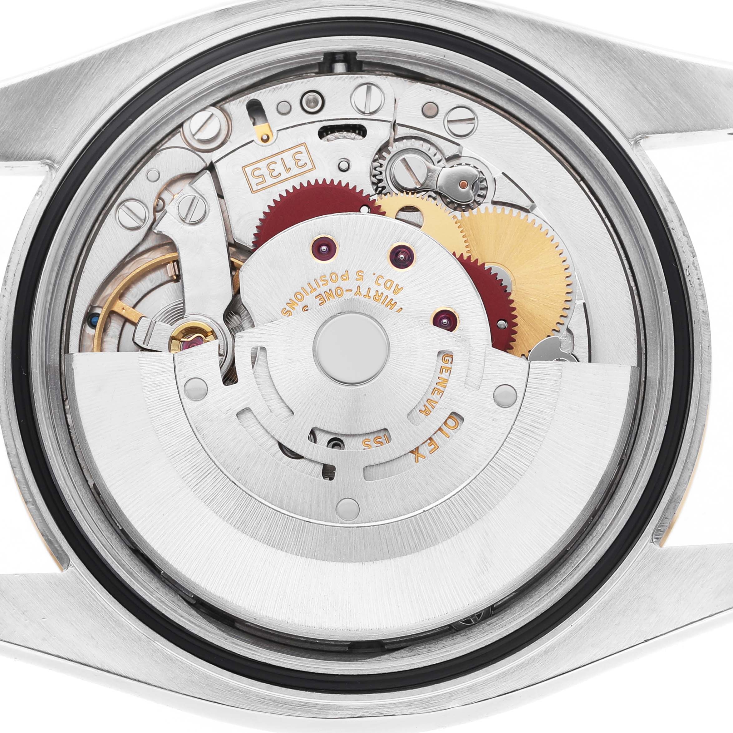 The image shows the movement of a Rolex Datejust 116233 Men's Steel and Gold (two tone) Grey Dial watch from a rear angle, highlighting gears and mechanical components.