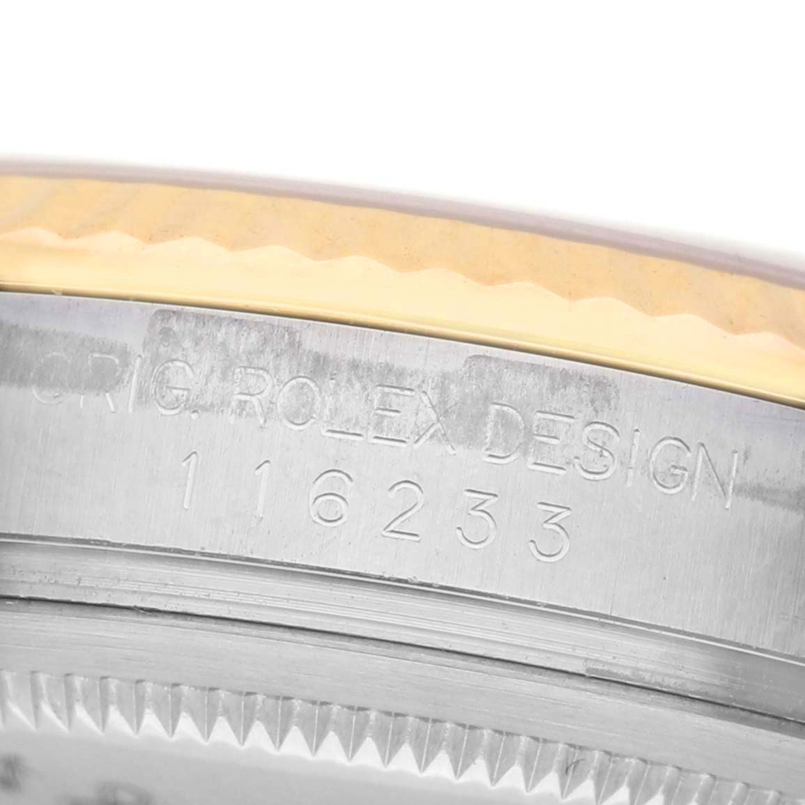 The image shows a close-up of the case side of a Rolex Datejust 116233 Men's Steel and Gold (two tone) Grey Dial, highlighting its engraved model number and design details.