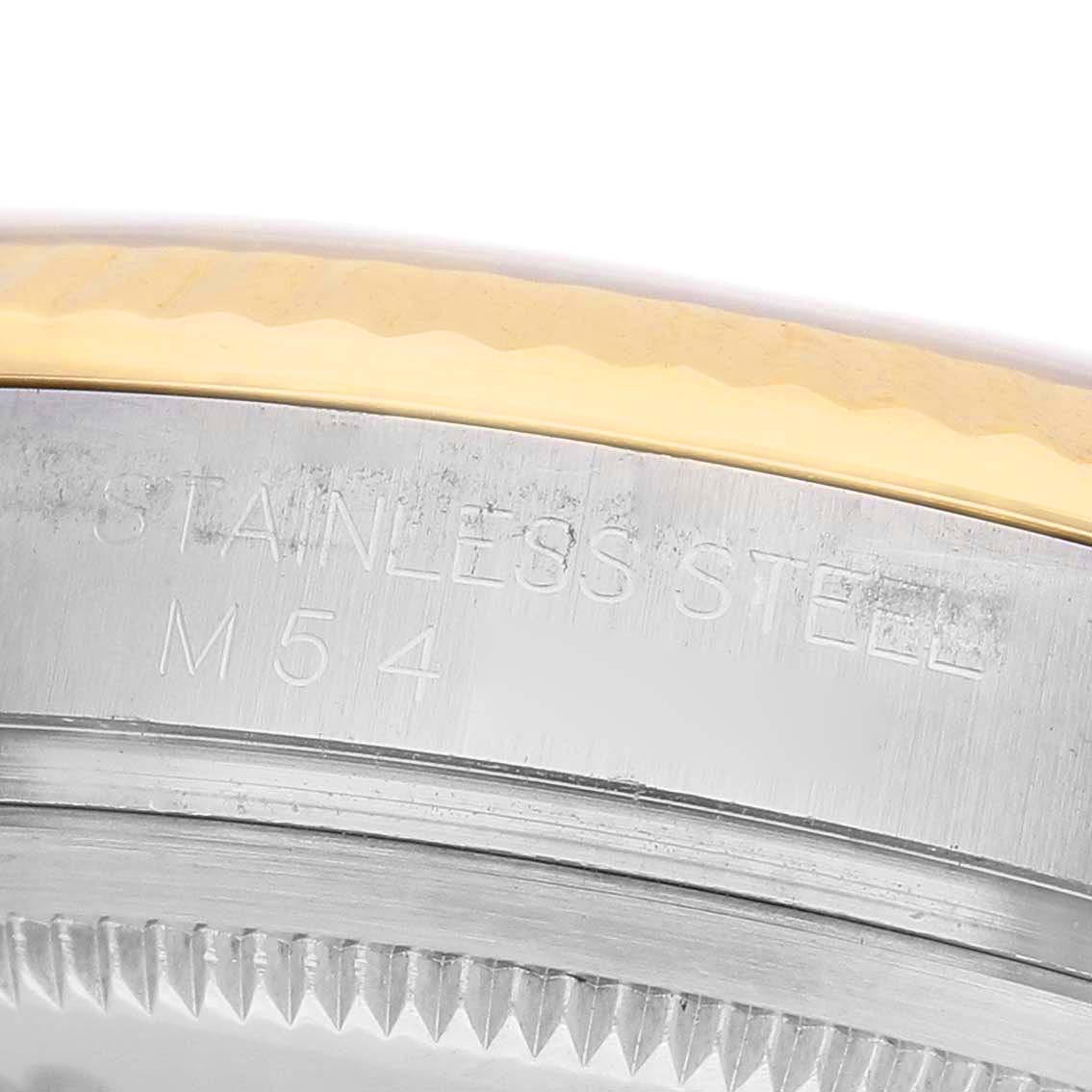 The image shows a close-up of the Rolex Datejust 116233 Men's Steel and Gold (two tone) Grey Dial watch's bezel and case, highlighting the stainless steel and engraving.