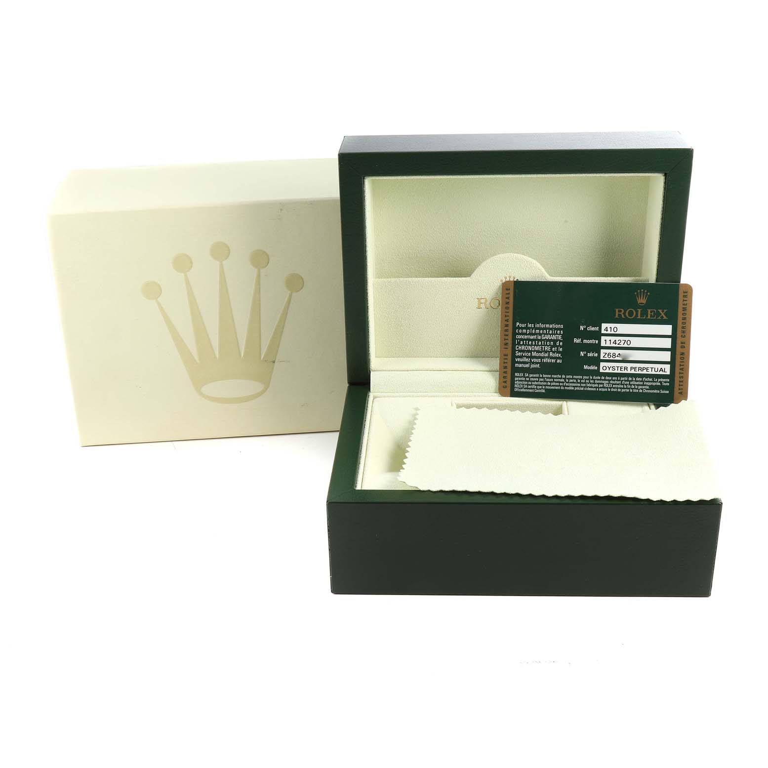 The image shows the opened box, warranty card, and cleaning cloth for a Rolex Explorer 114270 Men
s Stainless Steel Black Dial 114270 Men
s Stainless Steel Black Dial watch.