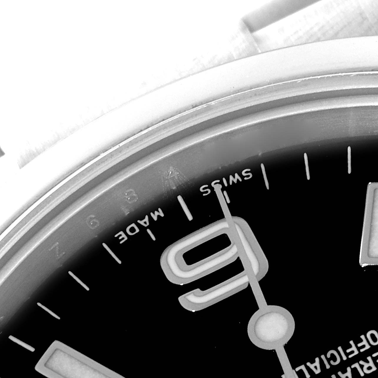 This image shows a close-up of the dial and part of the bezel of the Rolex Explorer 114270 Men
s Stainless Steel Black Dial 114270 Men
s Stainless Steel Black Dial watch, highlighting the "SWISS MADE" text and the 9 o
clock marker.