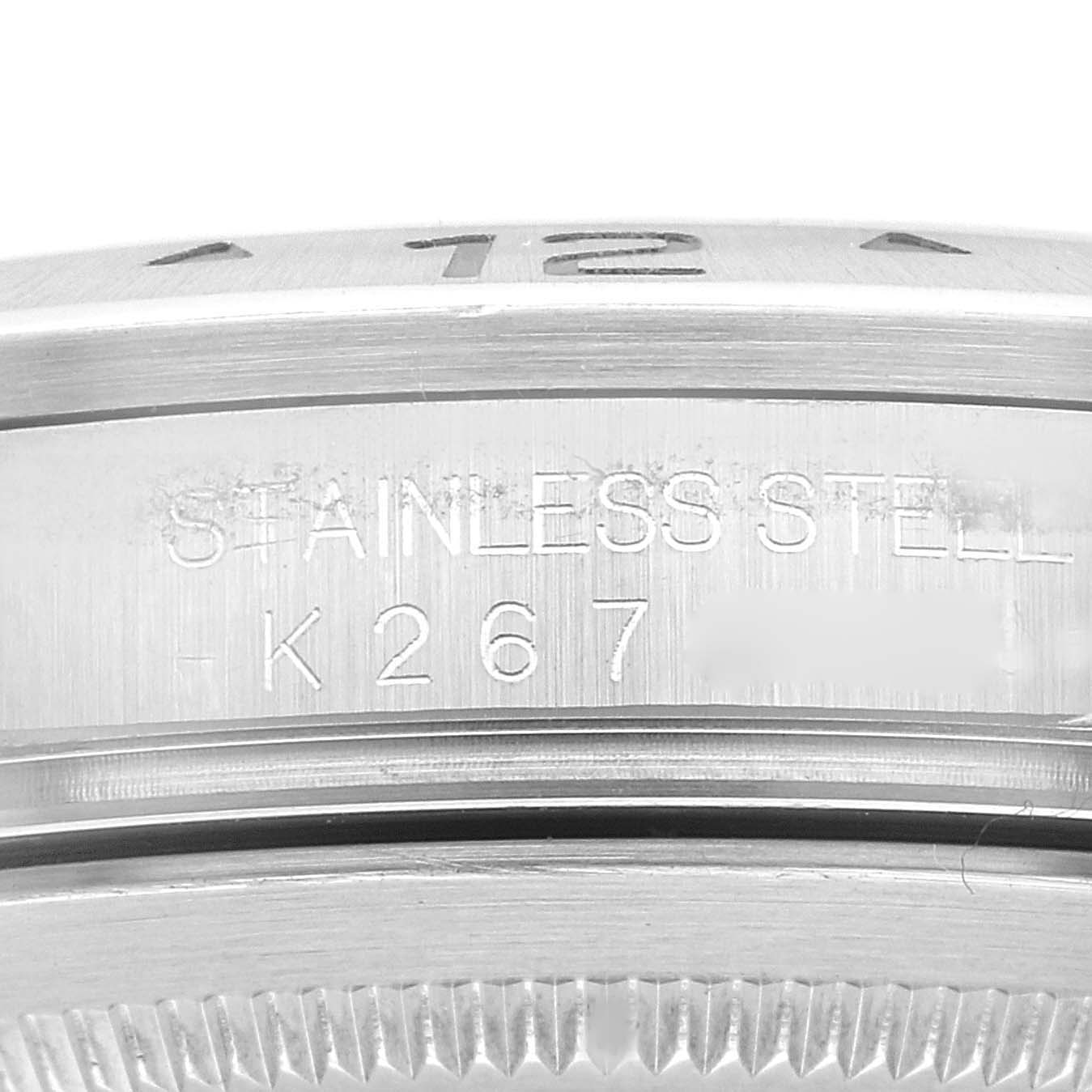 This close-up image displays the side engraving of a Rolex Explorer 16570 Men
s Stainless Steel White Dial 16570 Men
s Stainless Steel White Dial watch, highlighting the text "STAINLESS STEEL" and a partial serial number.