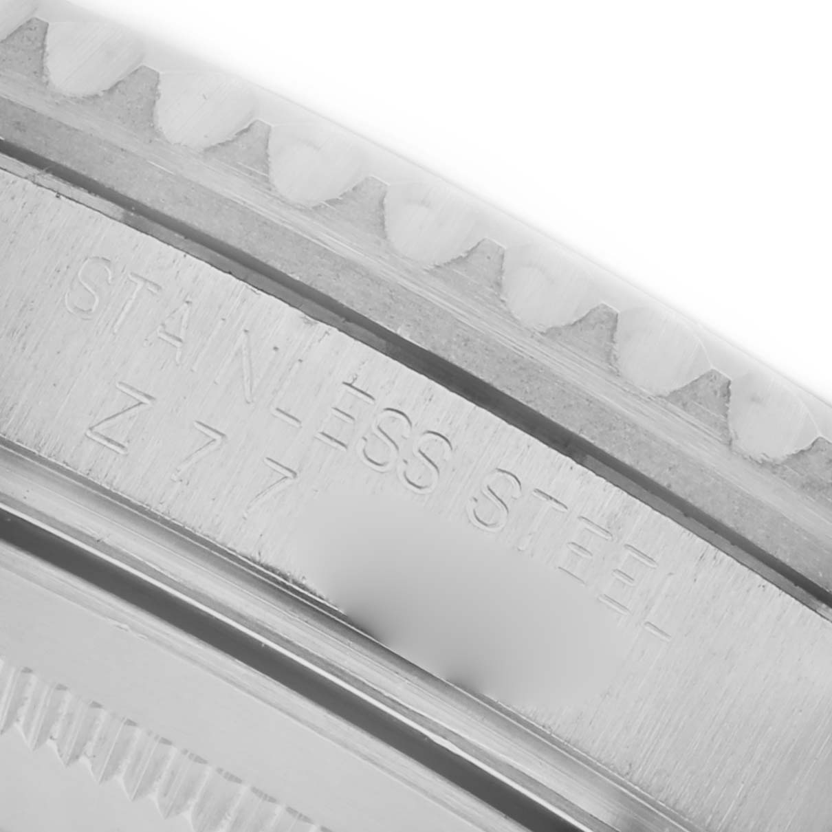 The image shows a close-up of the bezel and the engraved "STAINLESS STEEL" marking on a Rolex GMT-Master 16710 Men's Stainless Steel Black Dial 16710 Men's Stainless Steel Black Dial.