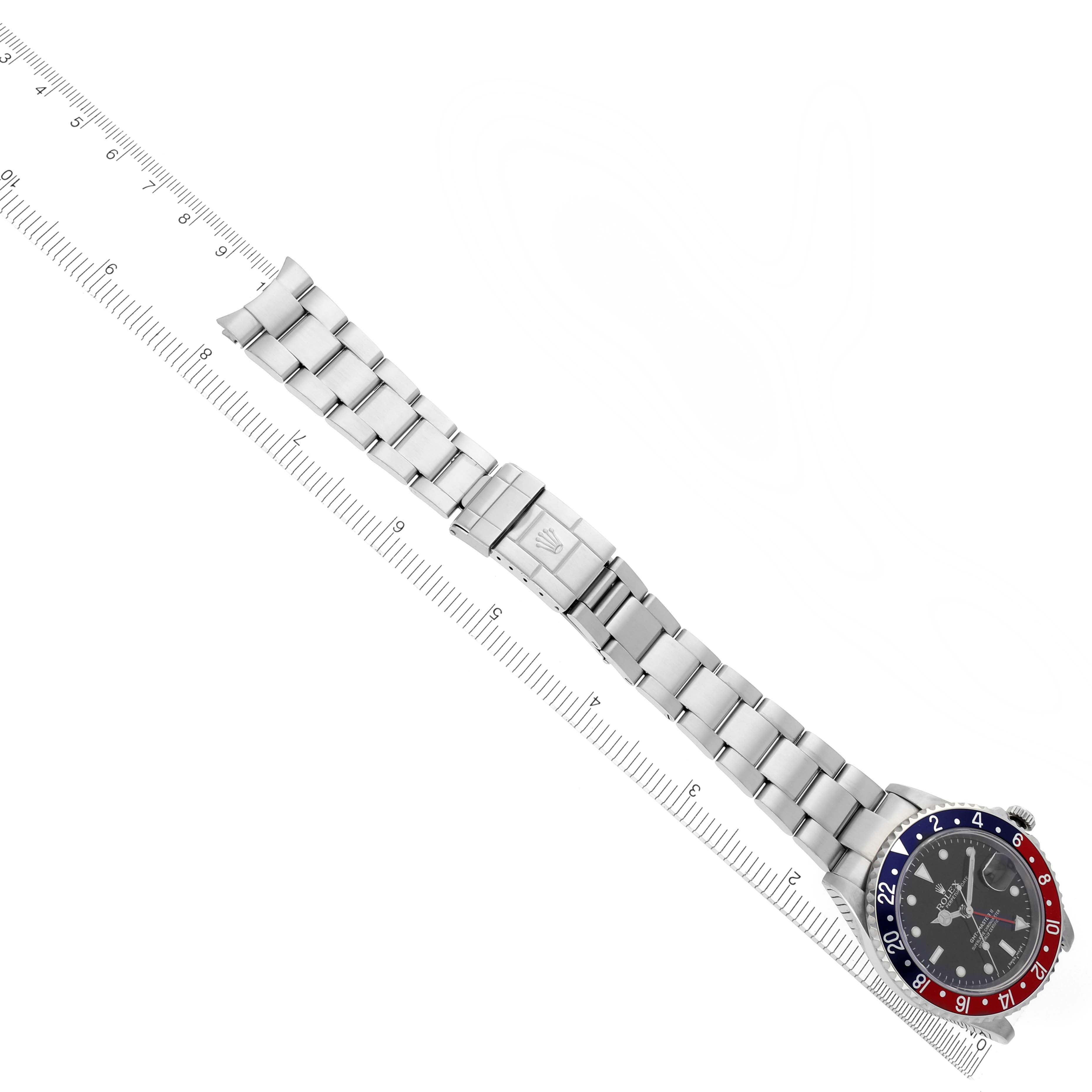 The image shows a Rolex GMT-Master 16710 Men's Stainless Steel Black Dial 16710 Men's Stainless Steel Black Dial watch at an angled top view, displaying the bezel, dial, and full bracelet alongside a ruler.